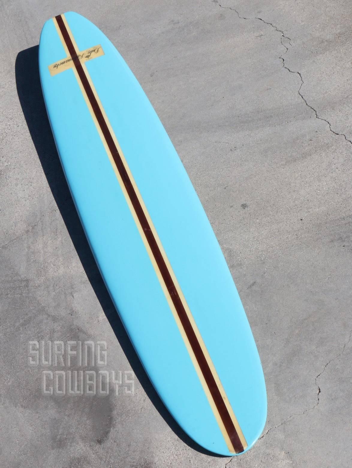 Bright, vibrant and glossy sky blue is accented by the wide redwood stringer which demonstrates that this Classic Hawaiian longboard was made to have the strength needed to ride the wildest of North Shore waves. This Classic surf collectible is