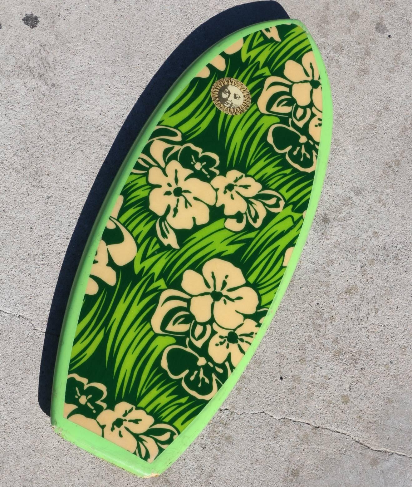This all original 1965 Dextra Bellyboard practically explodes with vibrant shades of spring green. Graphic flowers and leaves adorn the deck and are accented by a solid green bottom. A wonderful slice of vintage California surf lifestyle and a
