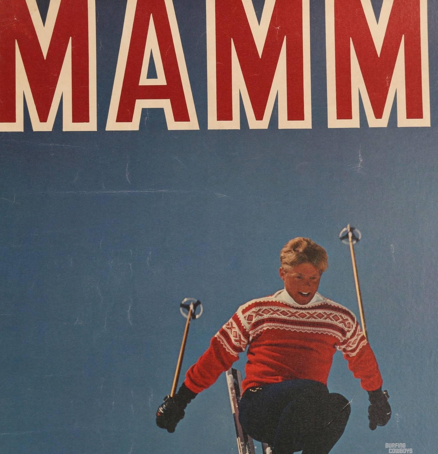 This all original Mammoth California ski poster, mounted on linen, is from the high speed photograph of a skier catching air in the snowy powder of the great Mammoth Mountain. Resplendent in his red and white woolen ski sweater and his healthy tan,