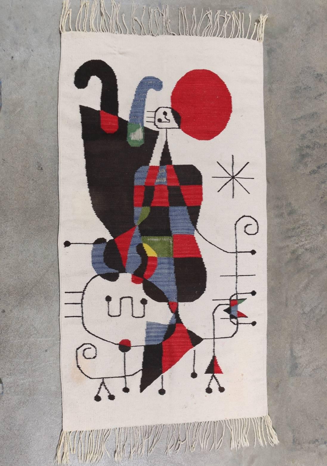 This woven rug features a beautiful composition inspired by the Spanish artist Joan Miró. Offered in vintage condition as found.

This item may be folded and shipped in a standard parcel.