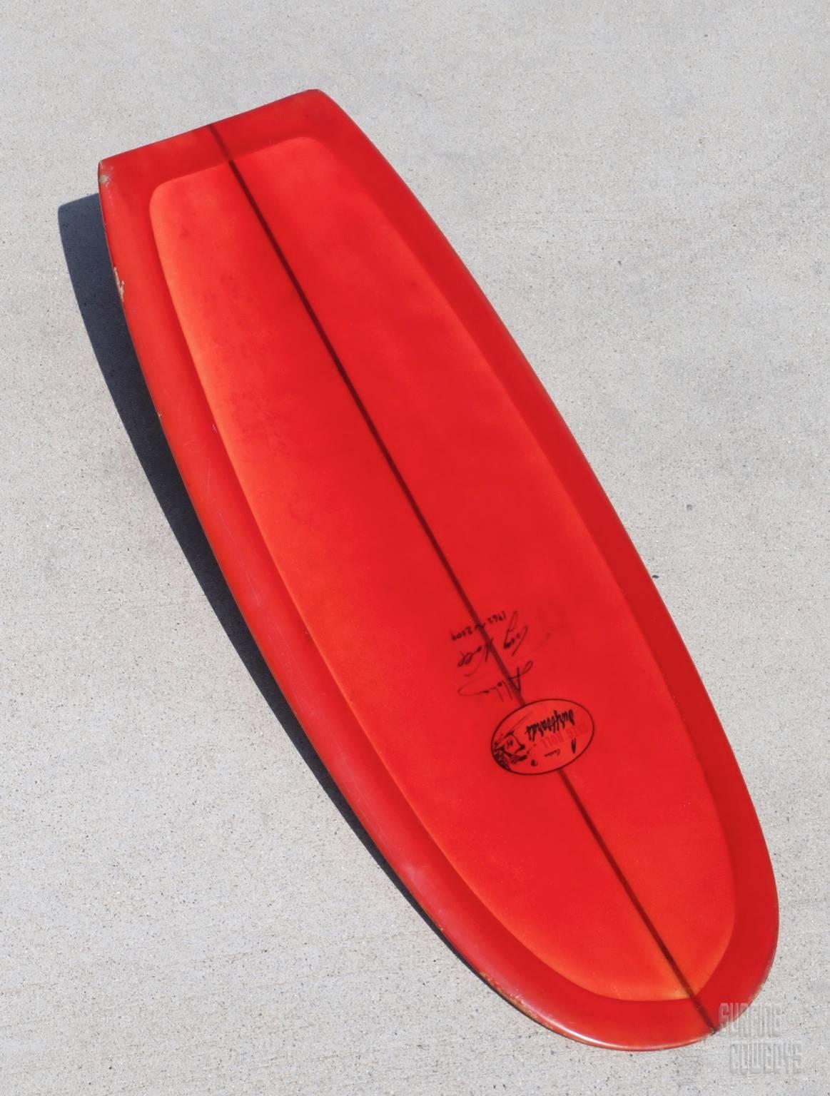 Greg Noll Belly Board, Paipo, All Original 1960s, Signed. Wonderful modest size offers easy display. Fantastic deep red, single 1/4 inch stringer, clear logo, long raking glassed-in wooden fin, pressure dings and a couple of un-repaired edge dinged