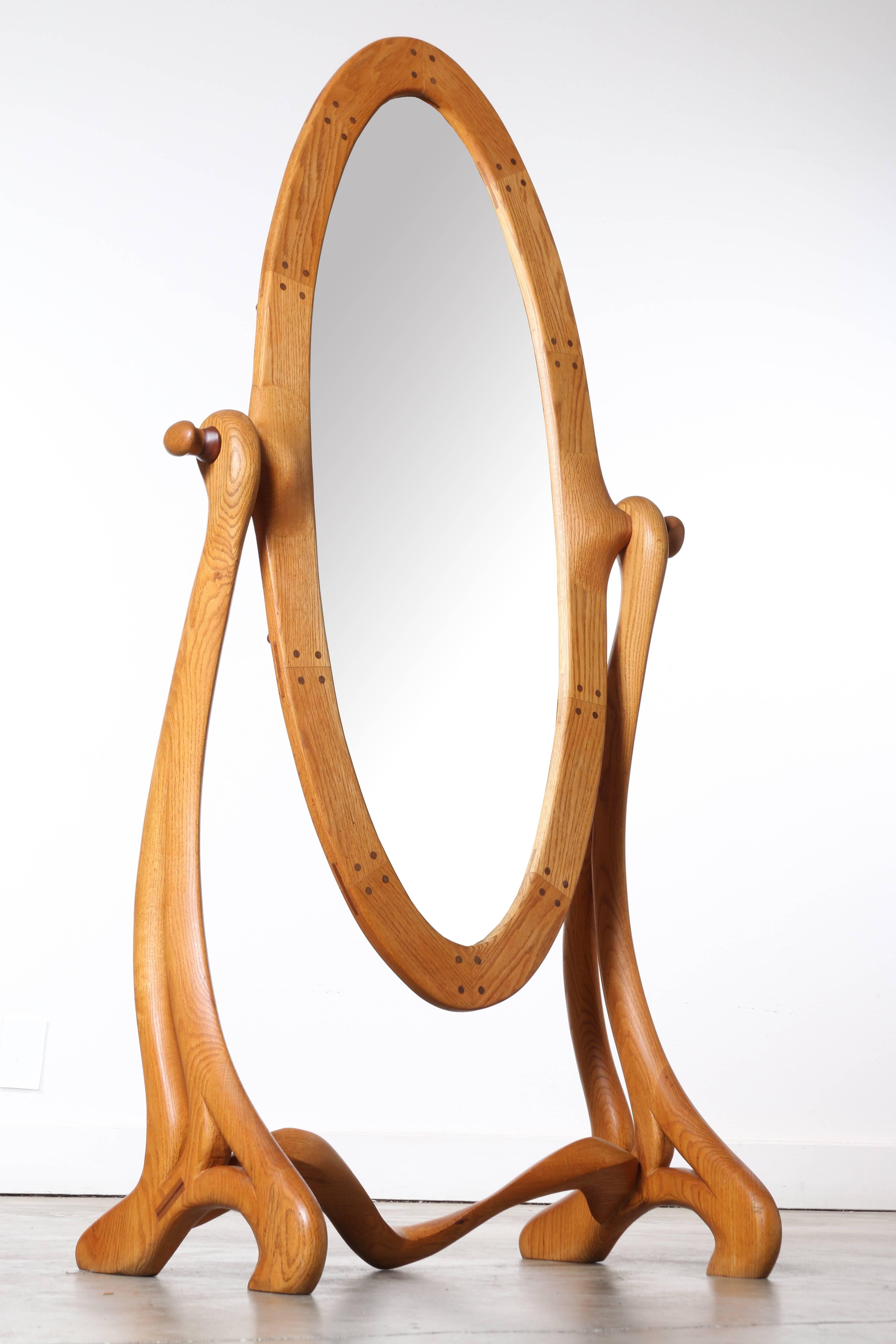 Wonderful organic lines on this California School floor mirror. All turned wood construction with beautiful joints of biscuits and dowels. Mirror is held in place with wooden wishbone holders, it may be adjusted to any angle required and secured in