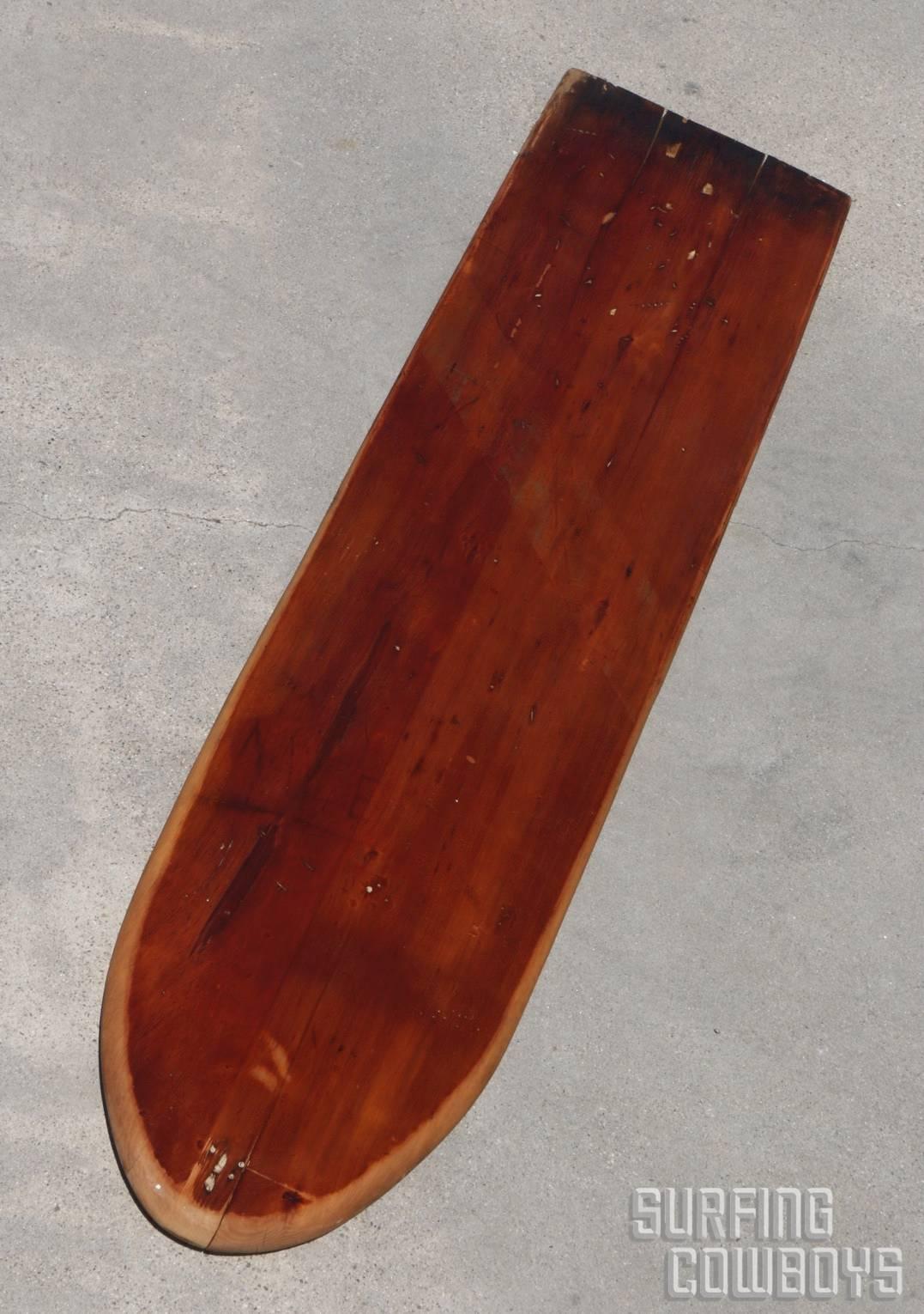 This wooden board was made from one piece of solid wood and retains its
original painted stripes. At just over seven feet long this board was a popular size for the time.  It's not too heavy and it's yet large enough for the rider to stand up on it