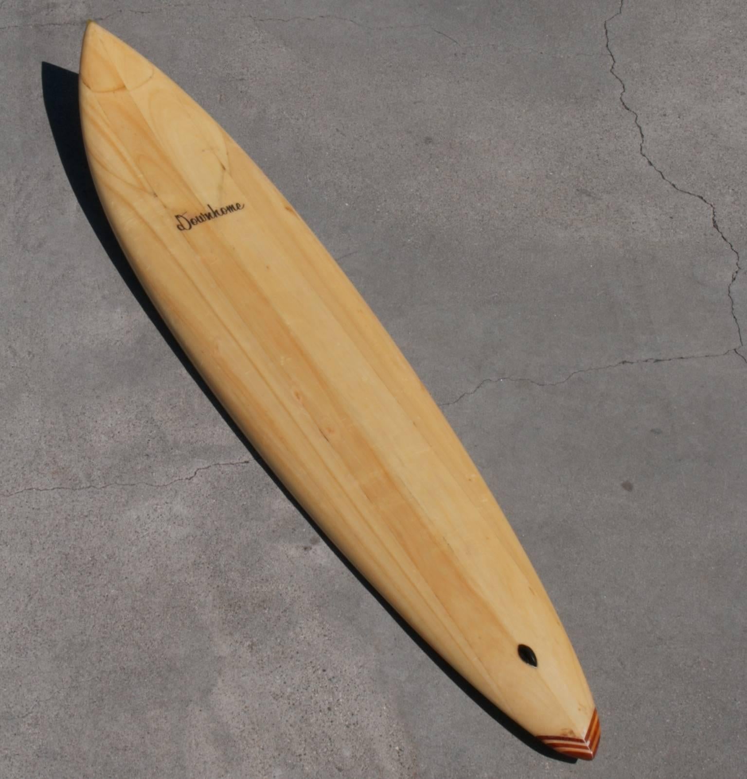 Balsa wood surfboard, Downhome shaped by Tom Gaglia, California, 1970s.
Elegant gun shaped board with stripes of alternating foam and wood used to create the tail block, down rails and good thickness, it screams 