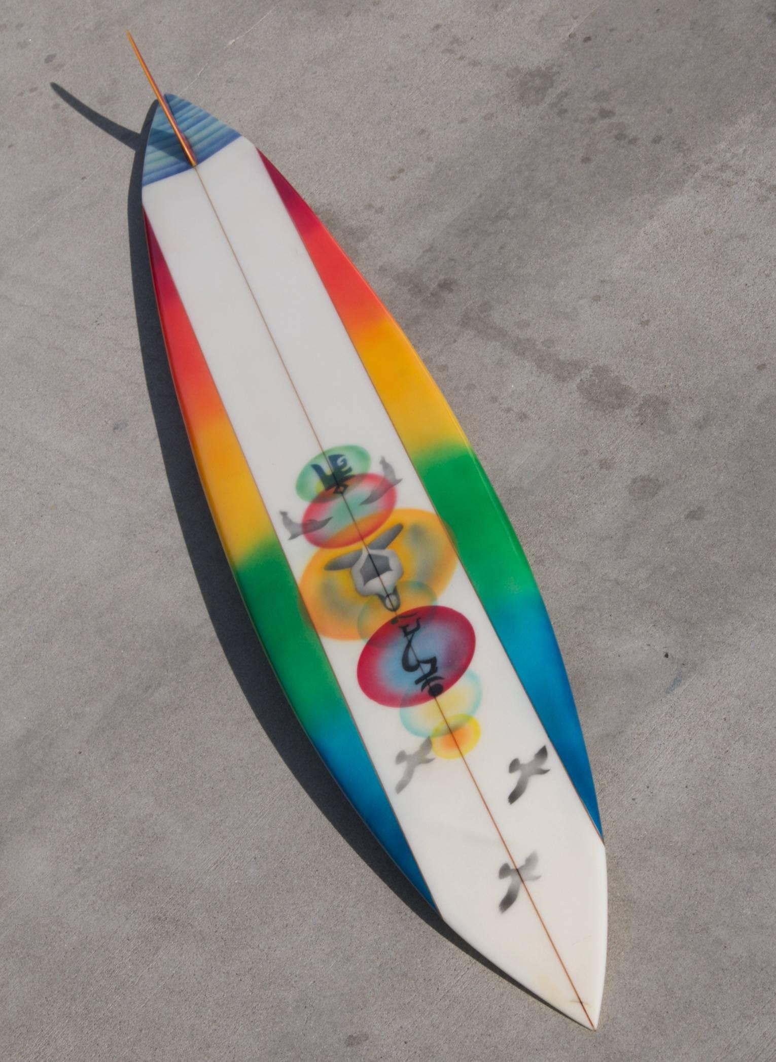 This brand new Mike Hynson hand shaped Rainbow big wave gun surfboard, incorporates an original 1960s rainbow logo and is enhanced with artwork by Eilers who offers up a rainbow spectrum of vibrant color and graphics on a tremendous shape that might