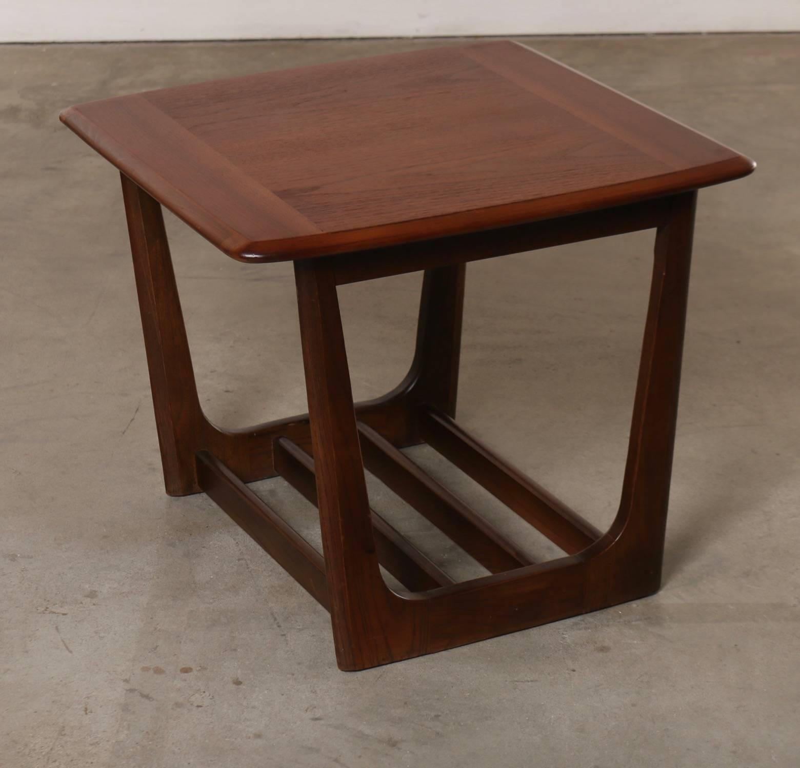 This pair of walnut Mid-Century side tables offer sizable dimension without the bulk often found in contemporary designs. The open frame construction supported by tapering bases with wood supports make these side tables, end tables sizable, sturdy