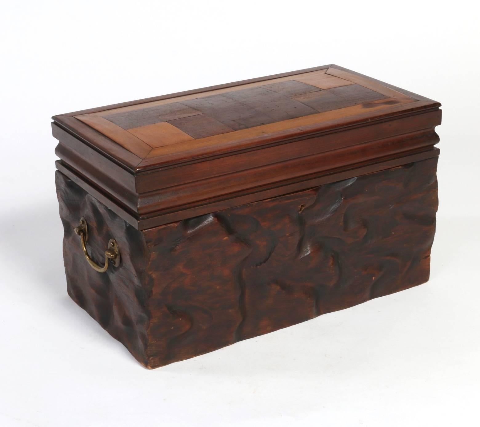Creatively made box of mixed wood species, accented on bottom with organic hewn natural bark, made circa 1890. The execution of the top exhibits the cabinet makers skills in precision woodworking and deftness in marquetry. The removable interior