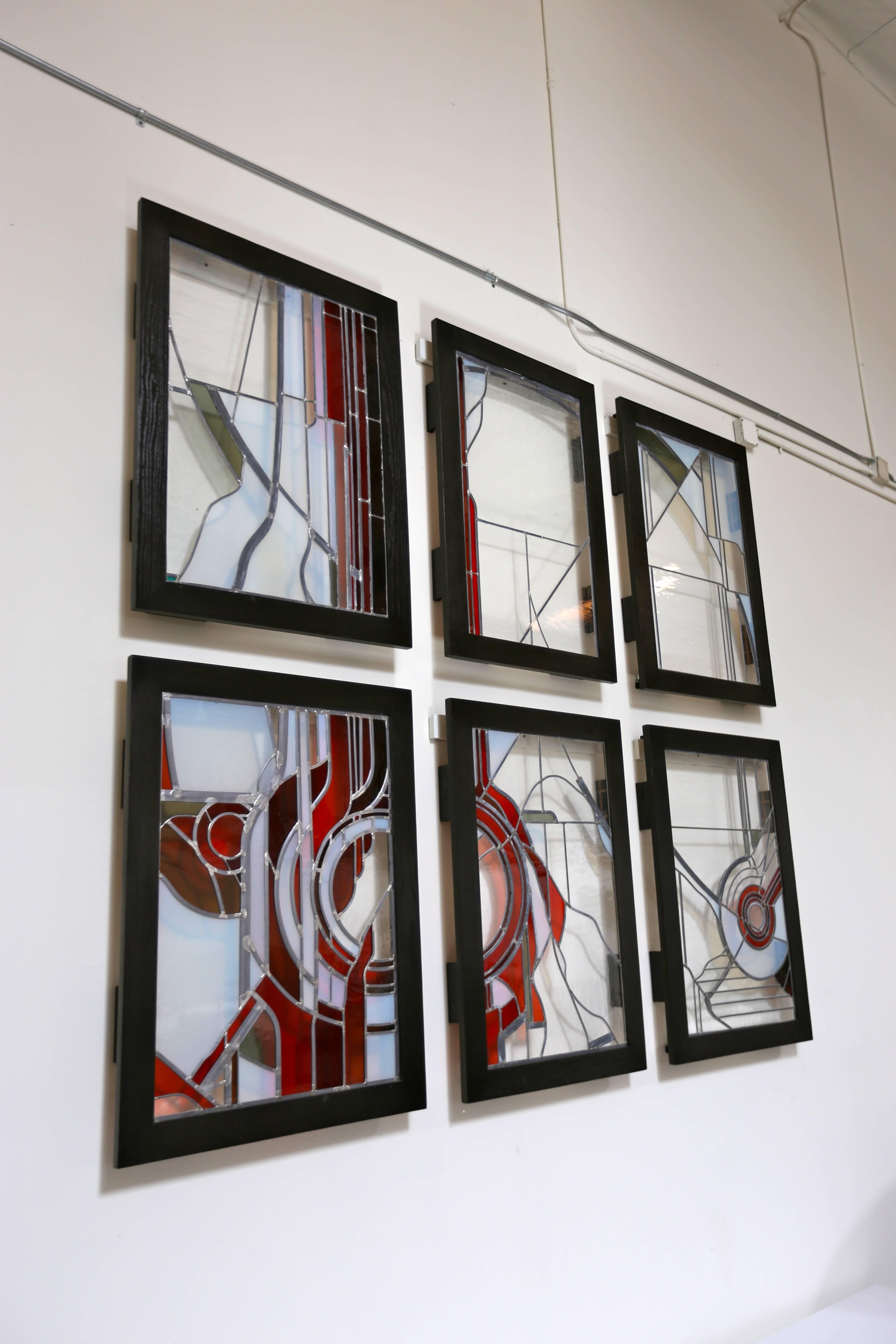 Studio Crafted stained glass abstraction. These pieces have been custom framed for display. 

Two panels measure: 30.5" wide x 41" tall x 3.5" deep.

Two panels measure: 27.25" wide x 41" tall x 3.5" deep. 

Two