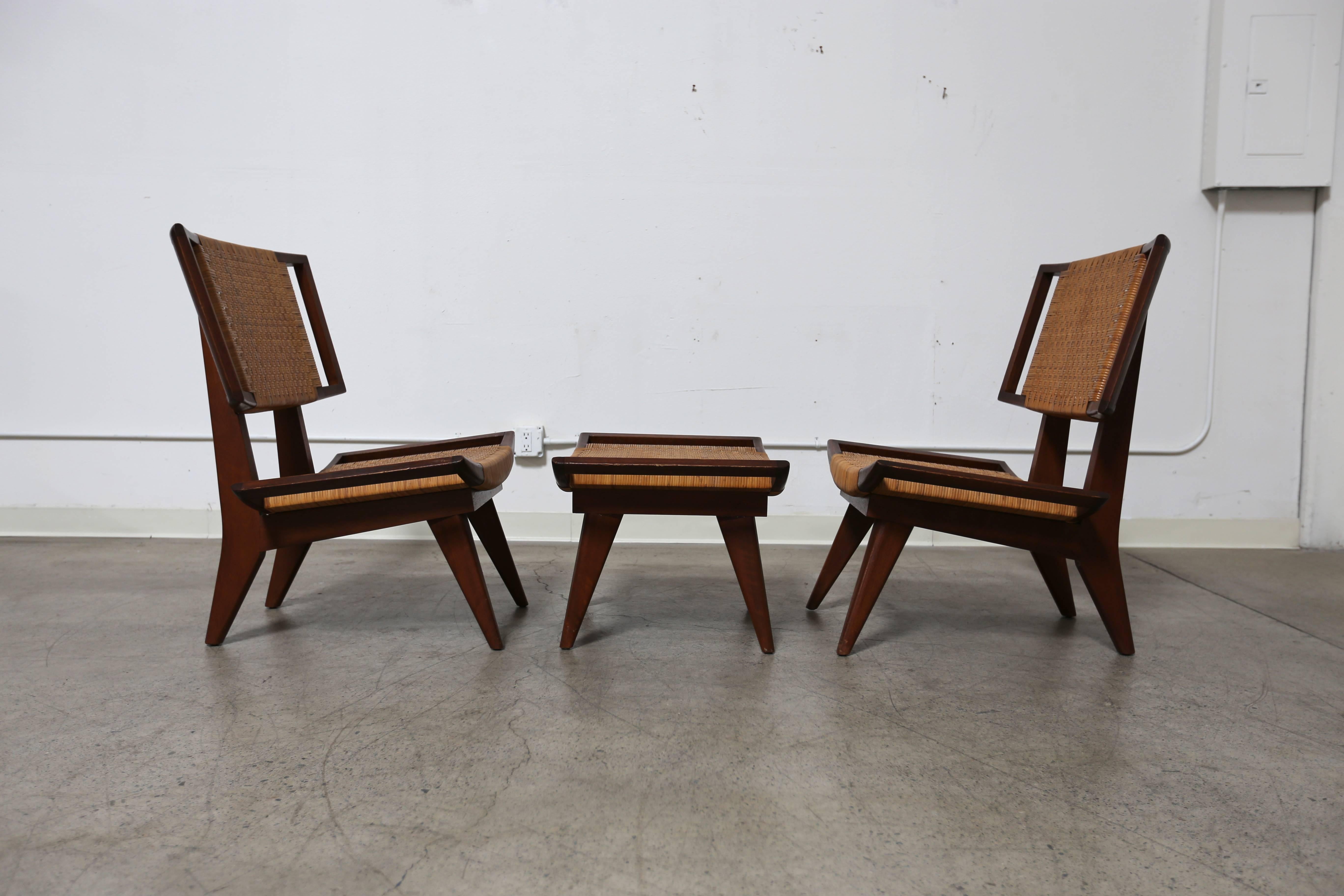 Pair of caned lounge chairs by Paul Laszlo. This set includes one ottoman. 

The ottoman measures 29