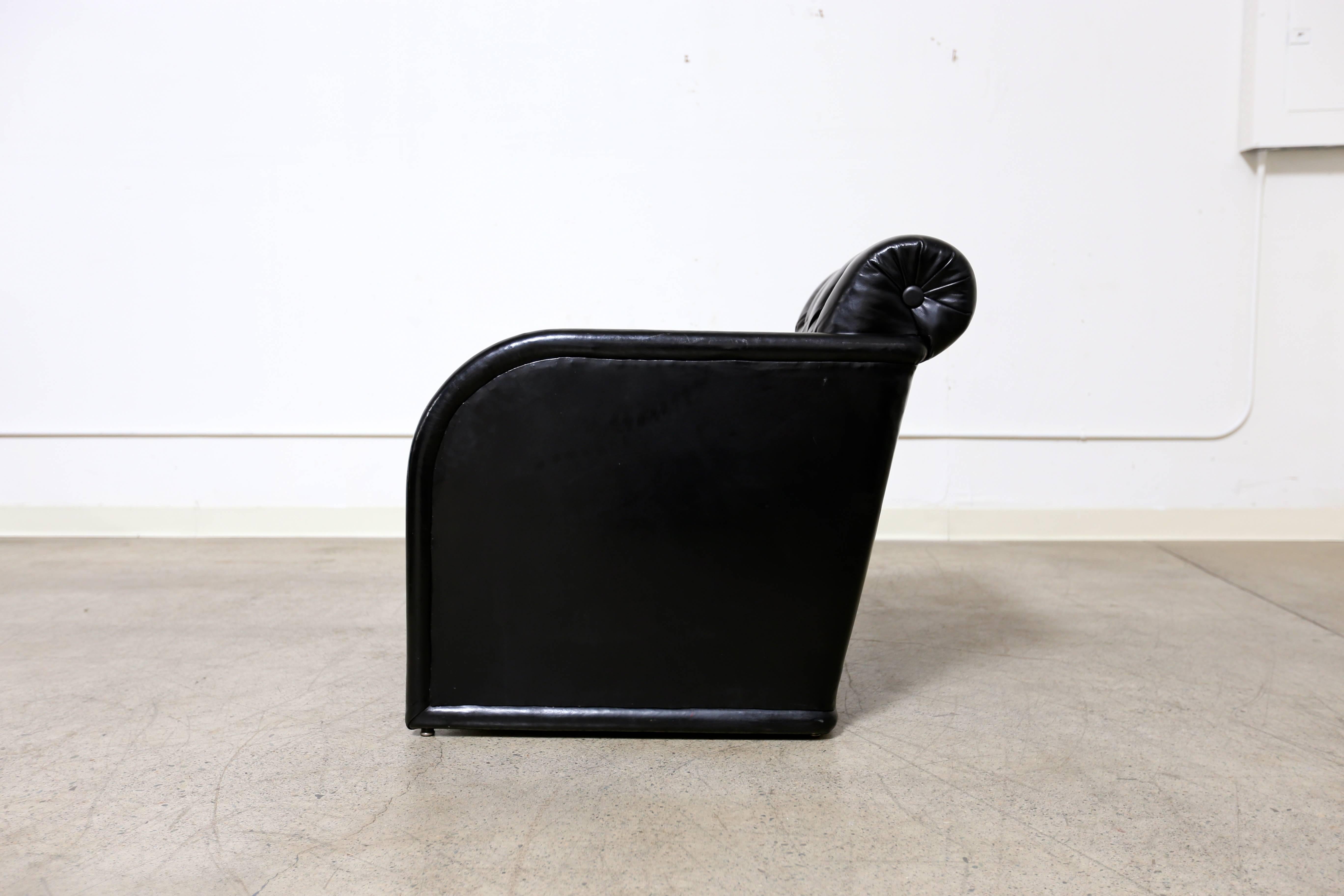 Modernist leather tufted lounge chair.
