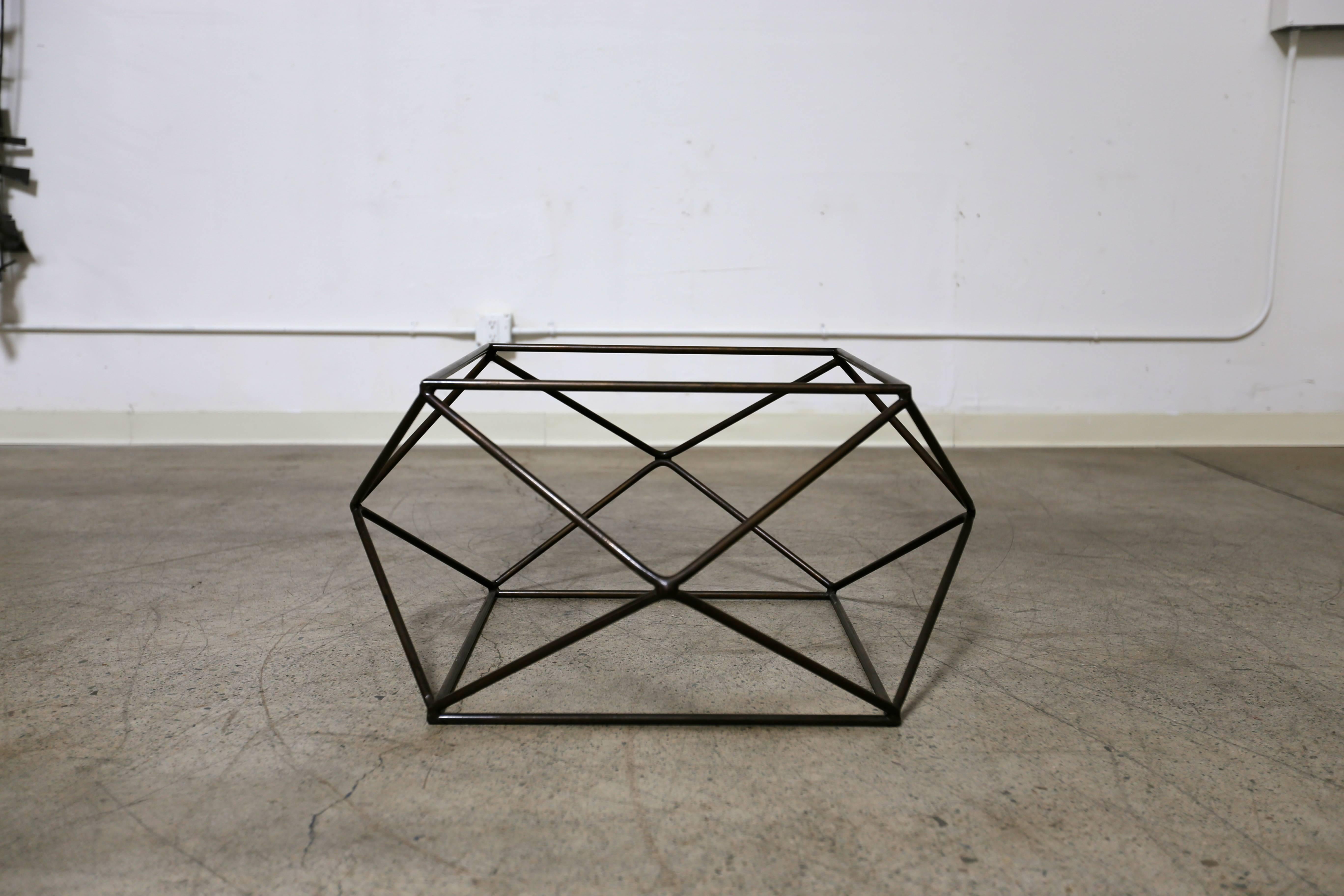 Geometric bronze finished and glass coffee table by Milo Baughman. Octagonal glass to the top.