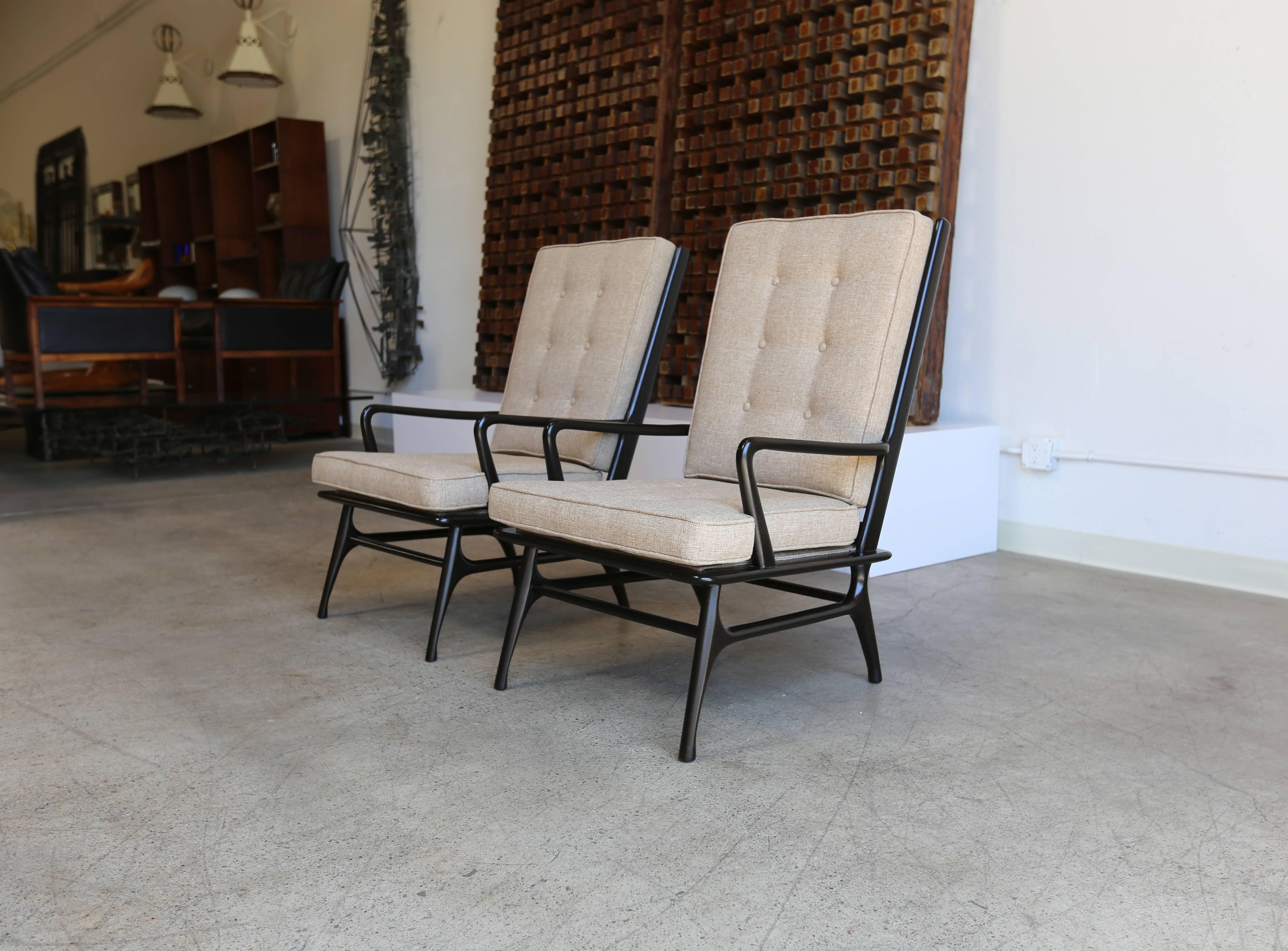 Pair of sculptural high back lounge chairs.