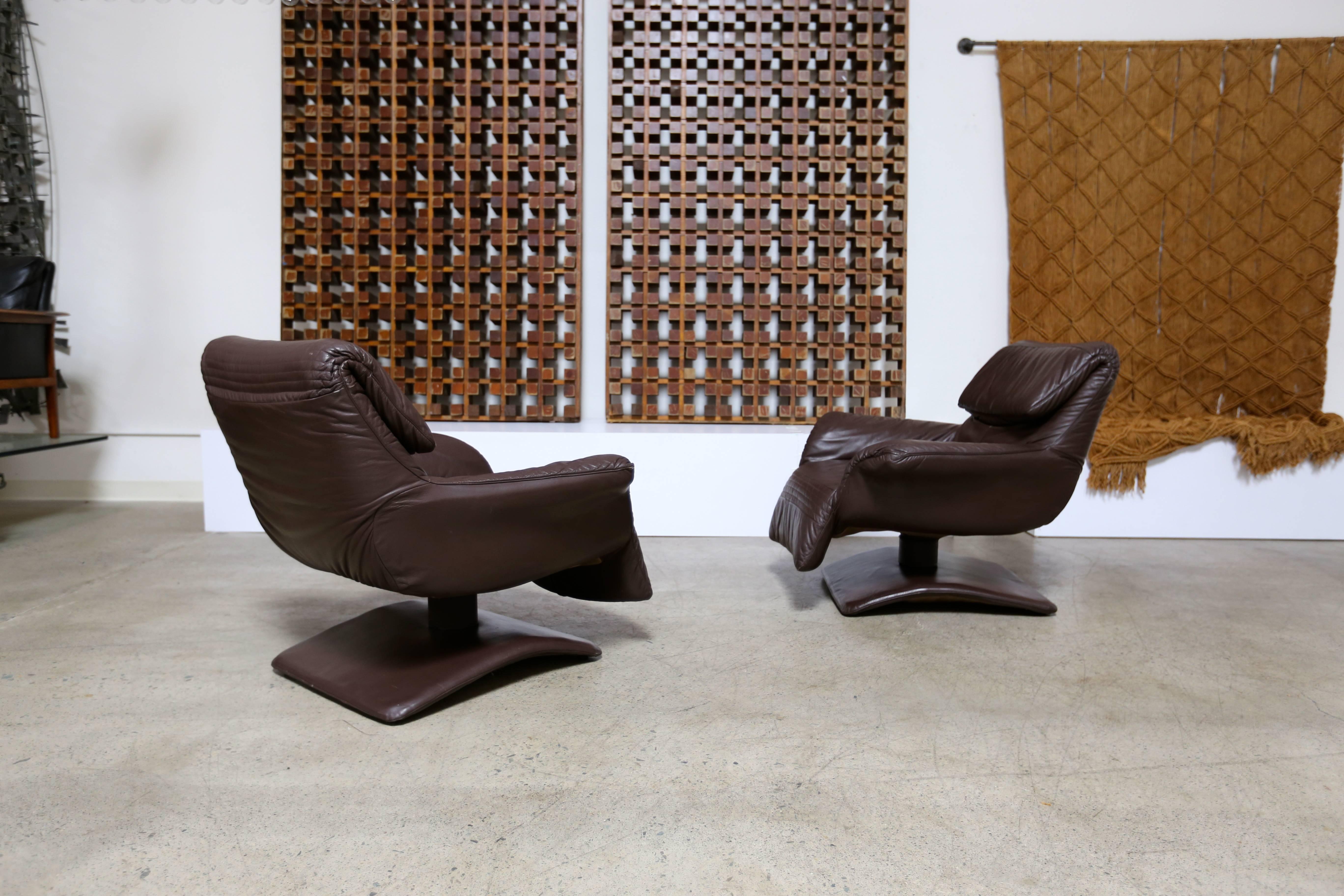 Pair of leather swivel lounge chairs. Measures: The headrest adjust from 31.5" to 41.5" from the floor to the top.