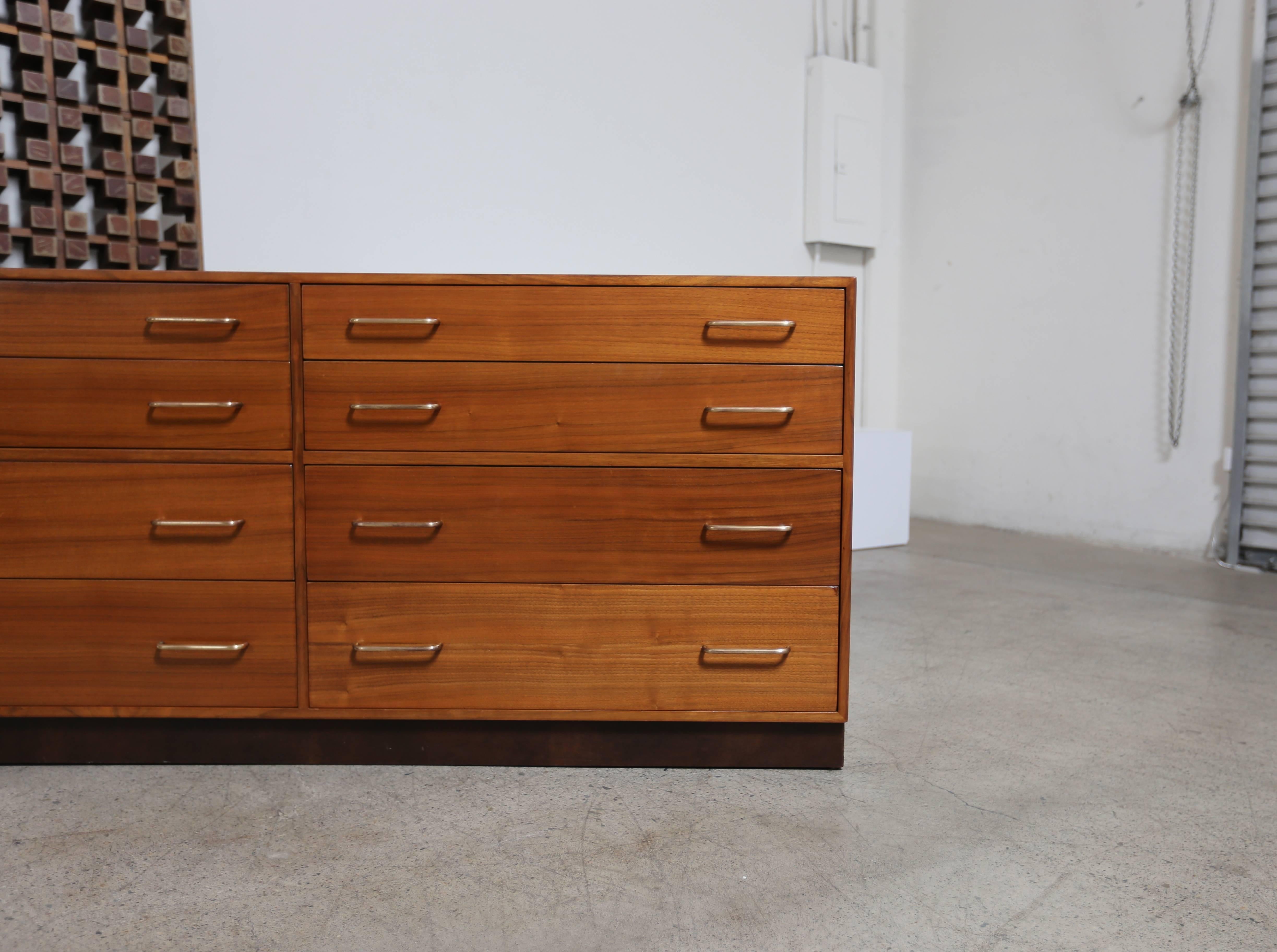 Walnut dresser by Edward Wormley for Dunbar. The base is wrapped in leather. Nice walnut grain throughout.

MOVING SALE!!!