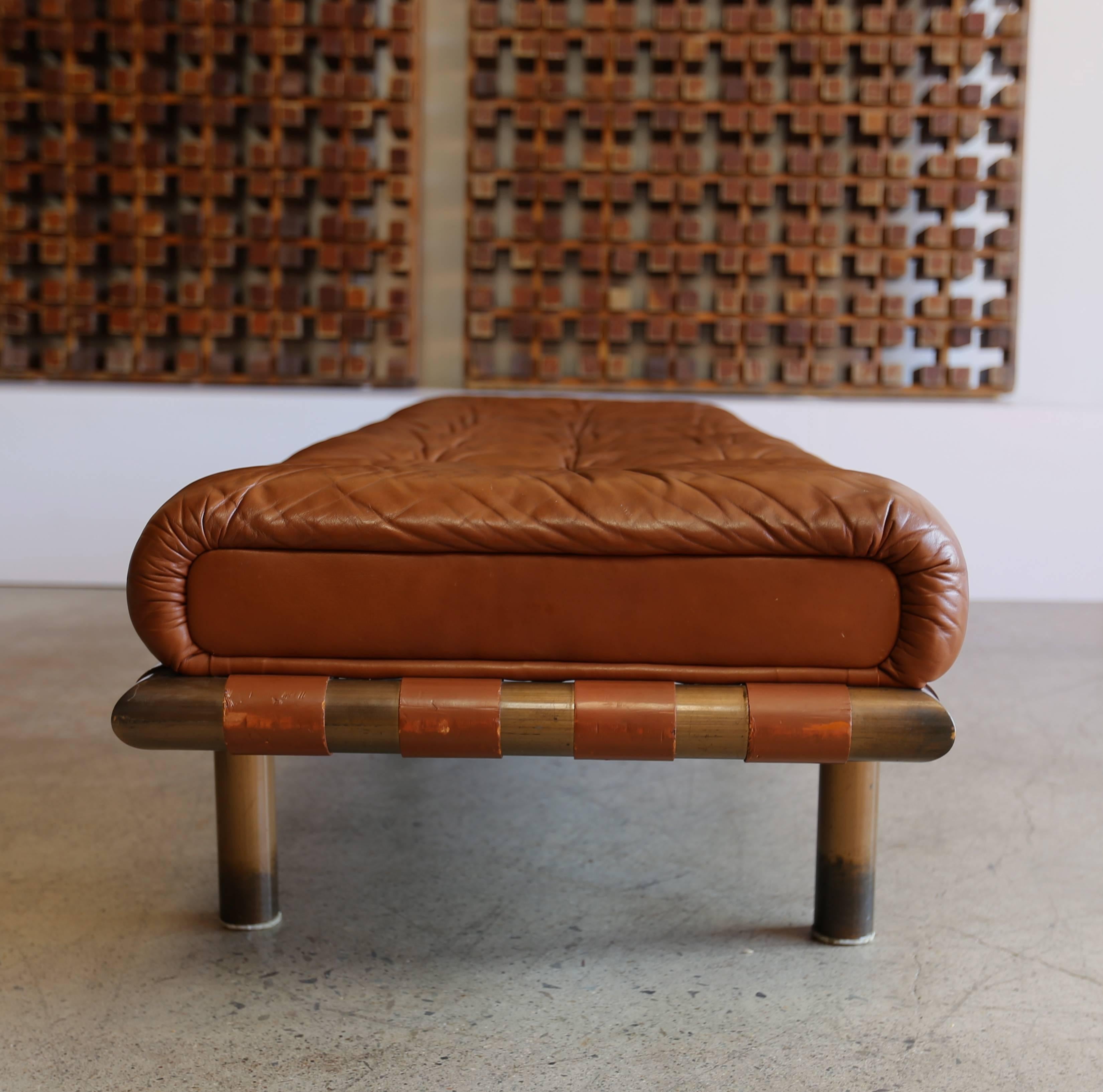 Brass and tufted leather bench.