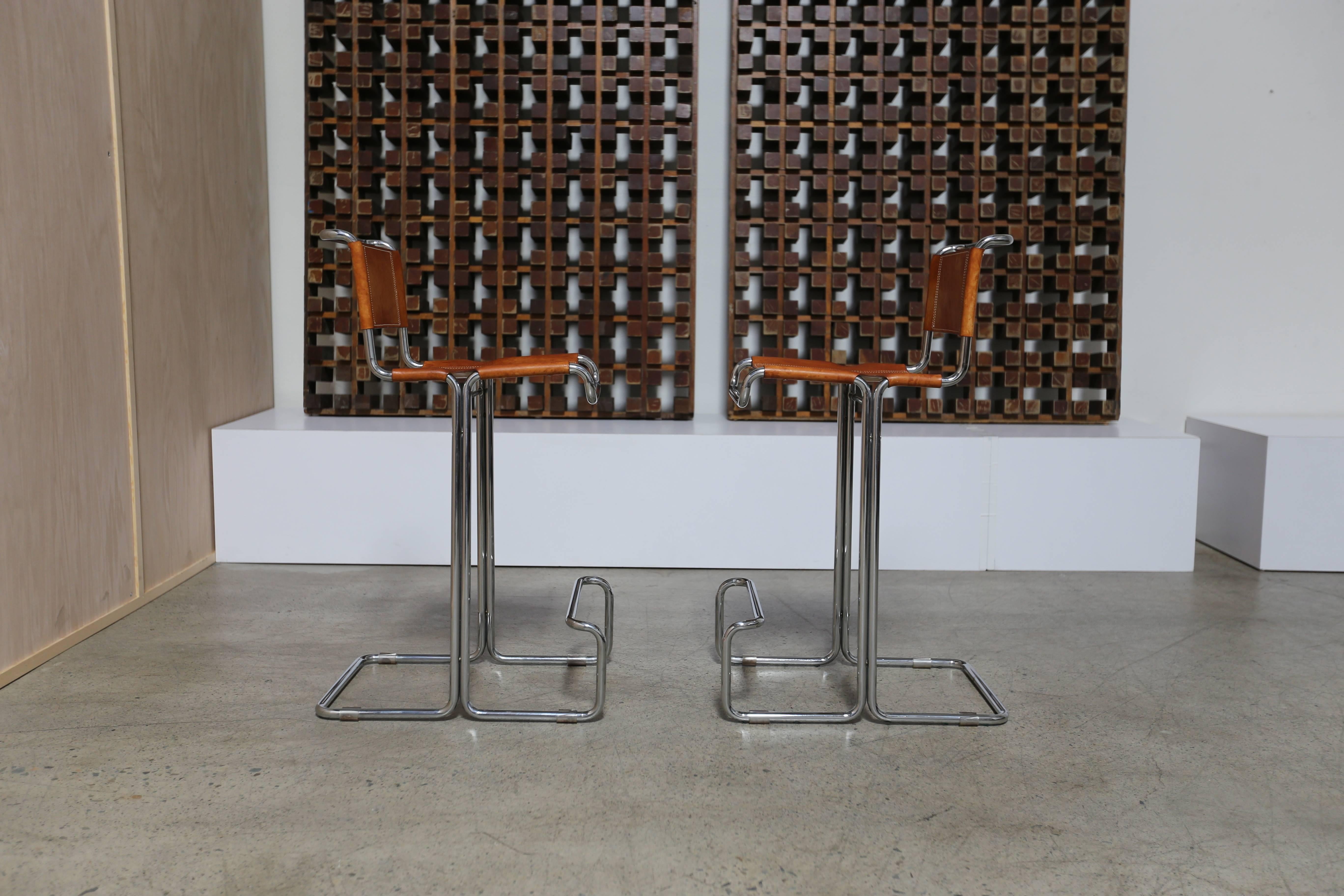 Pair of leather and chrome barstools by Stendig.