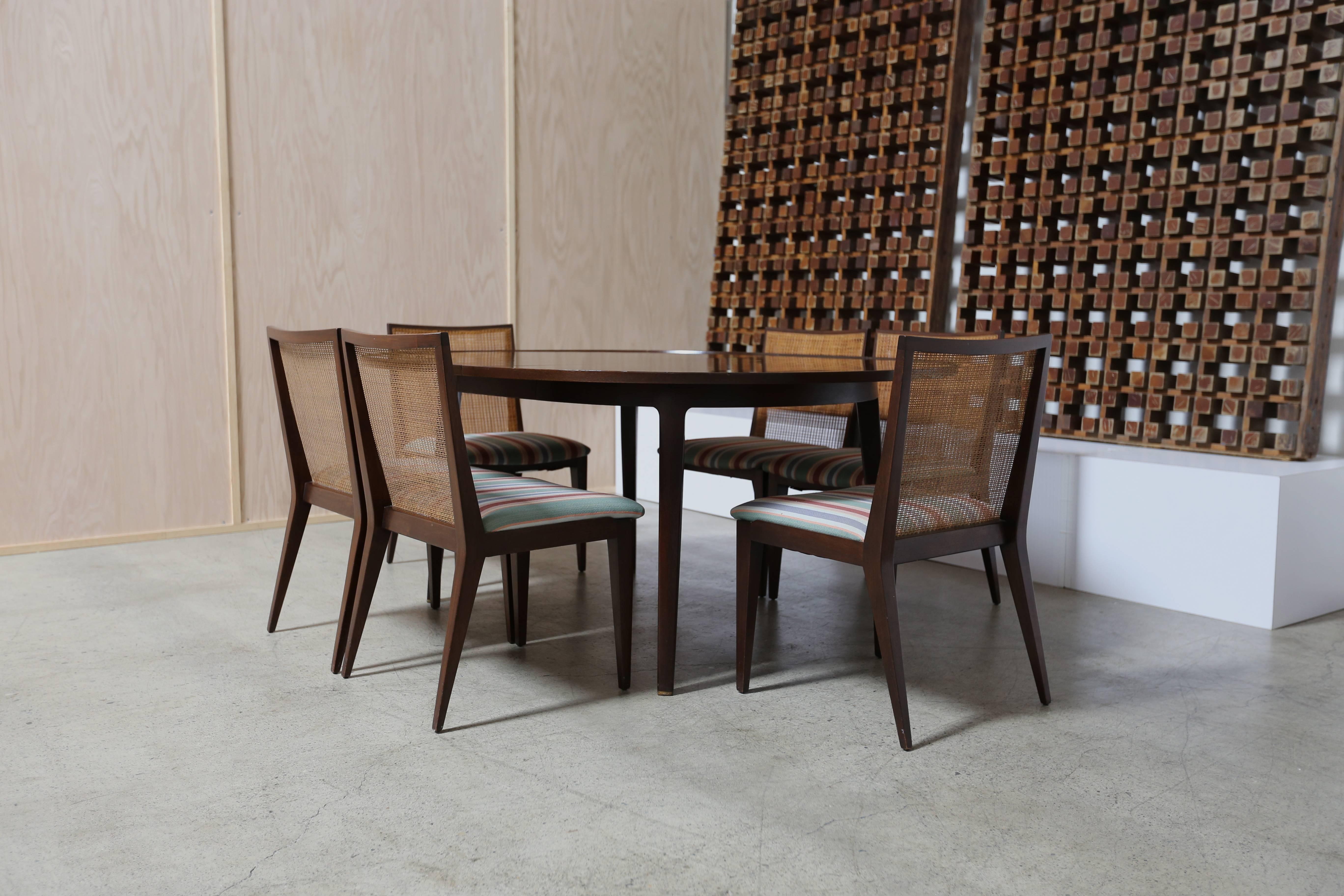 Dining set by Edward Wormley for Dunbar. Dining table with one leaf and six dining chairs.