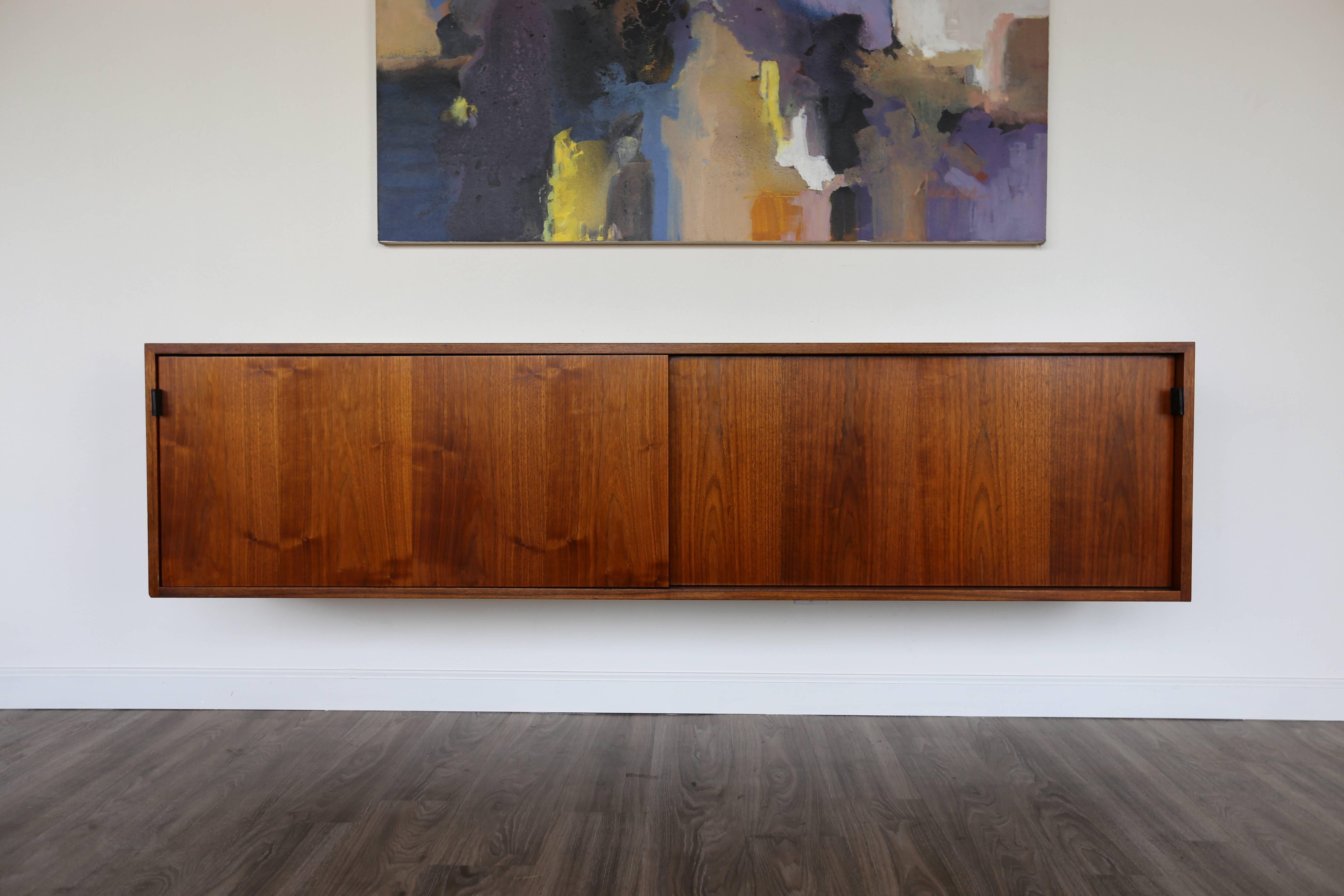 Walnut hanging credenza by Florence Knoll.