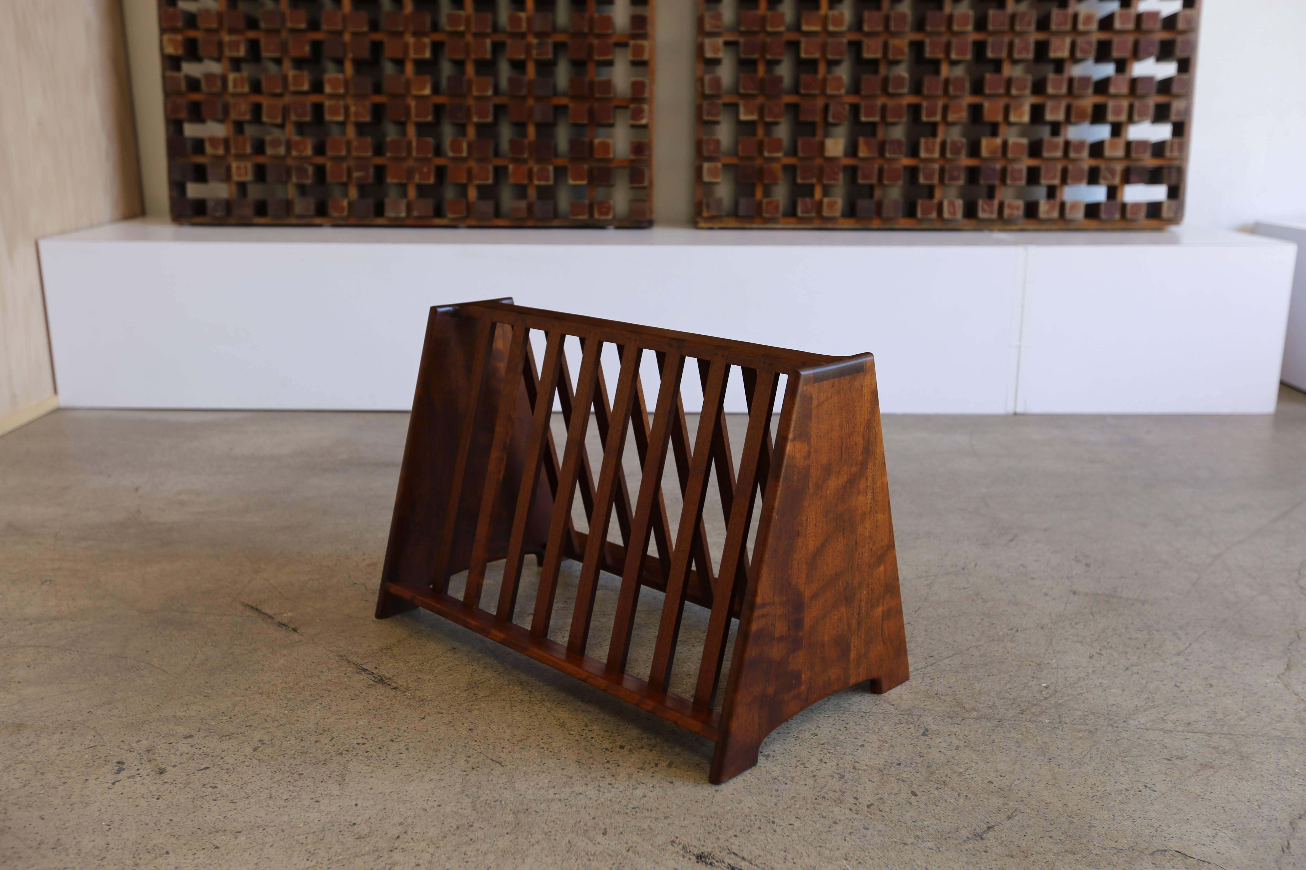Handcrafted Shedua wood magazine rack by John Nyquist. This piece is sold with the original handwritten paperwork from John Nyquist, 1968.