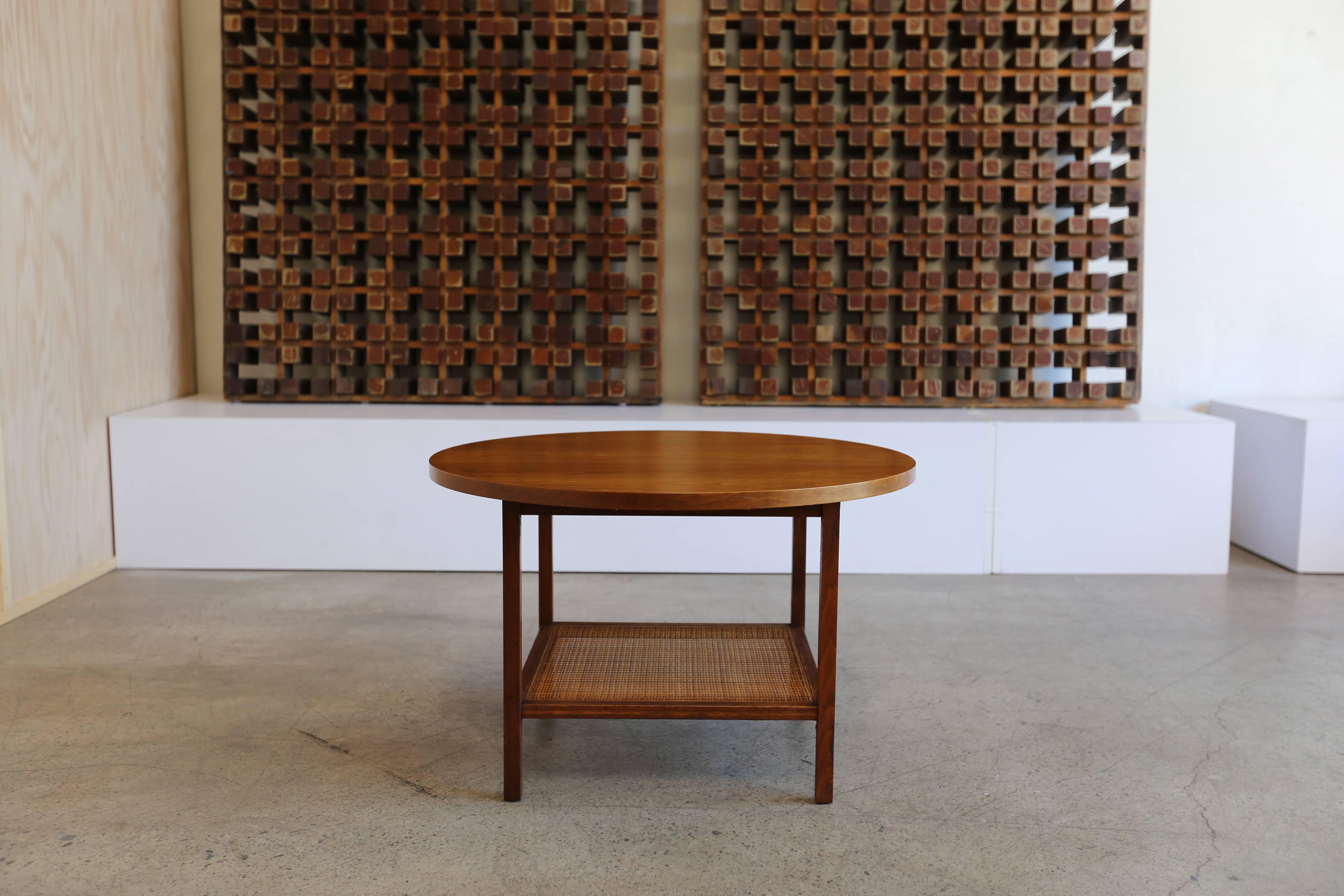 Round walnut and cane side table by Paul McCobb for Calvin Furniture Company.