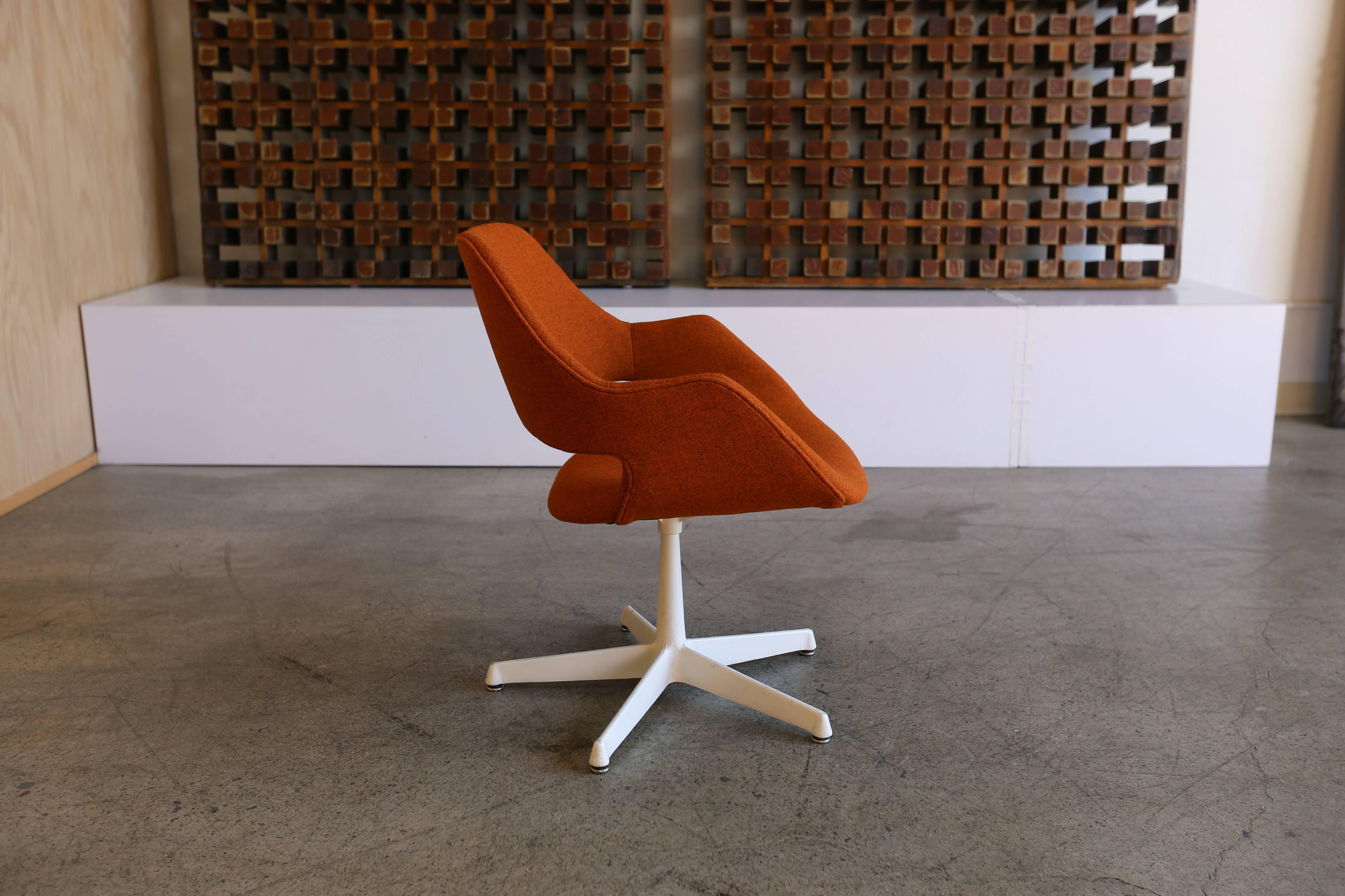 Swivel armchair by Arthur Umanoff for Madison Furniture. Upholstered in maharam tonica rust fabric.