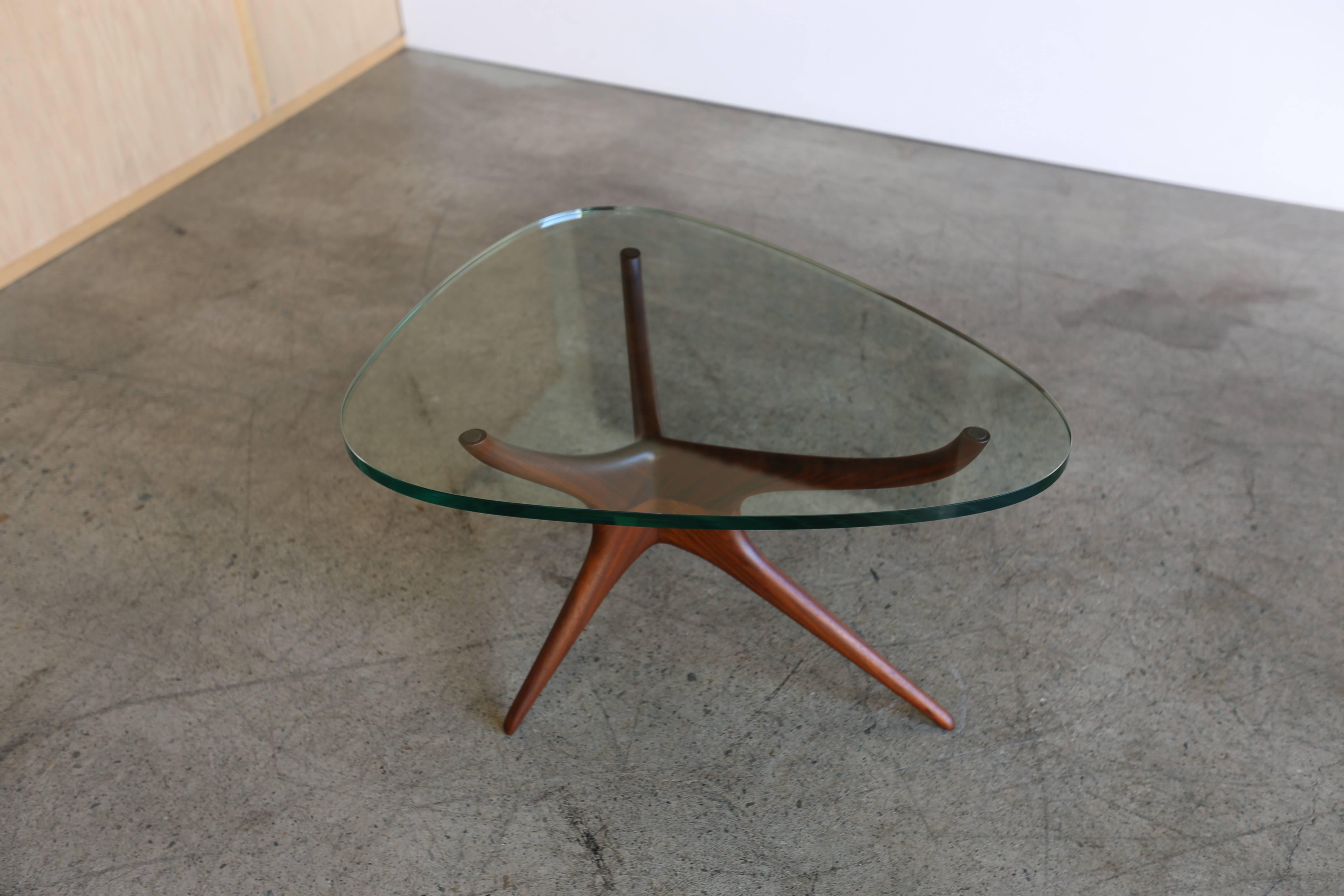 Tri-symmetric glass and walnut occasional table by Vladimir Kagan for Kagan-Dreyfuss, Inc.