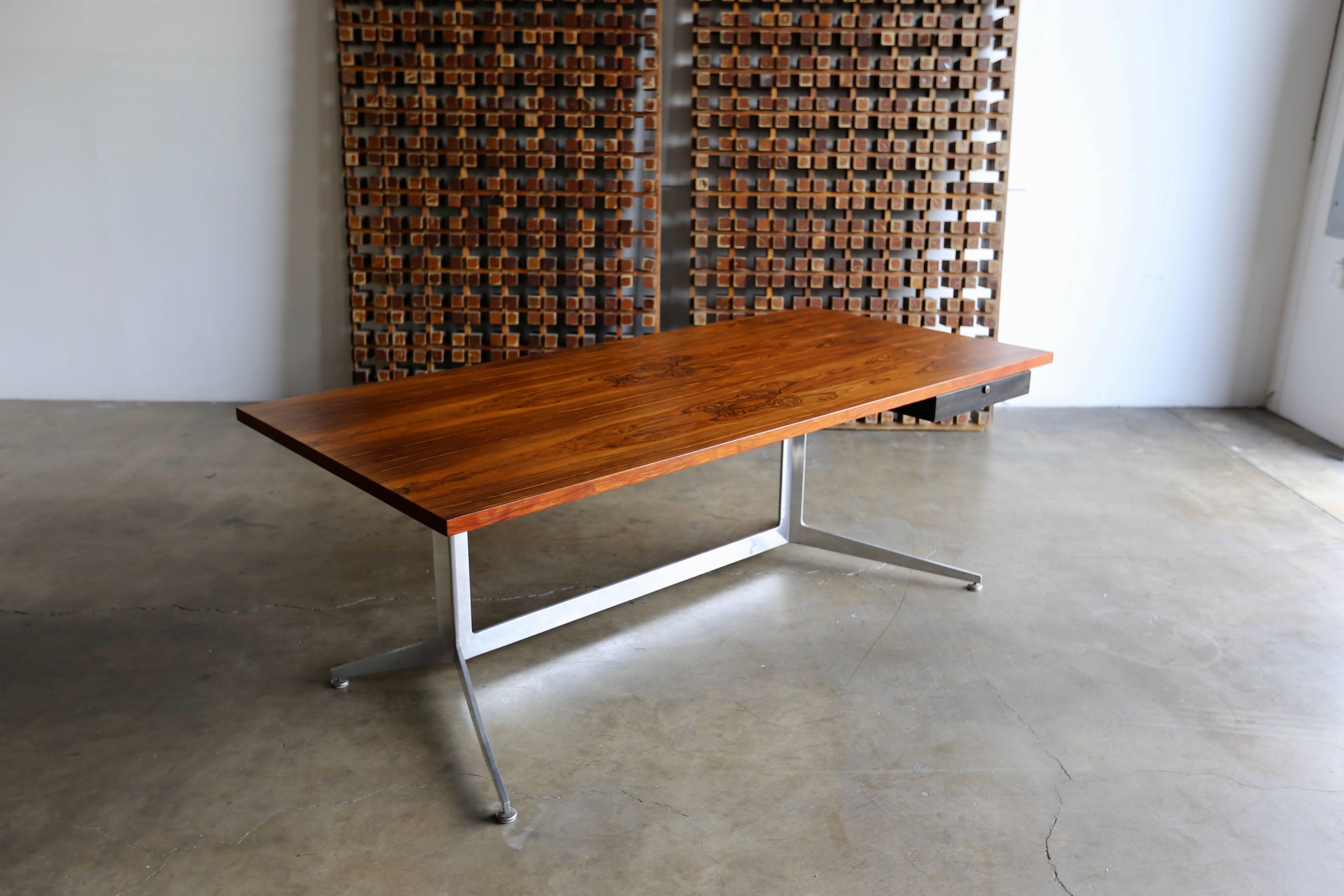 Highly figured rosewood desk by Ward Bennett for Lehigh Leopold, circa 1965. This desk features a single drawer.