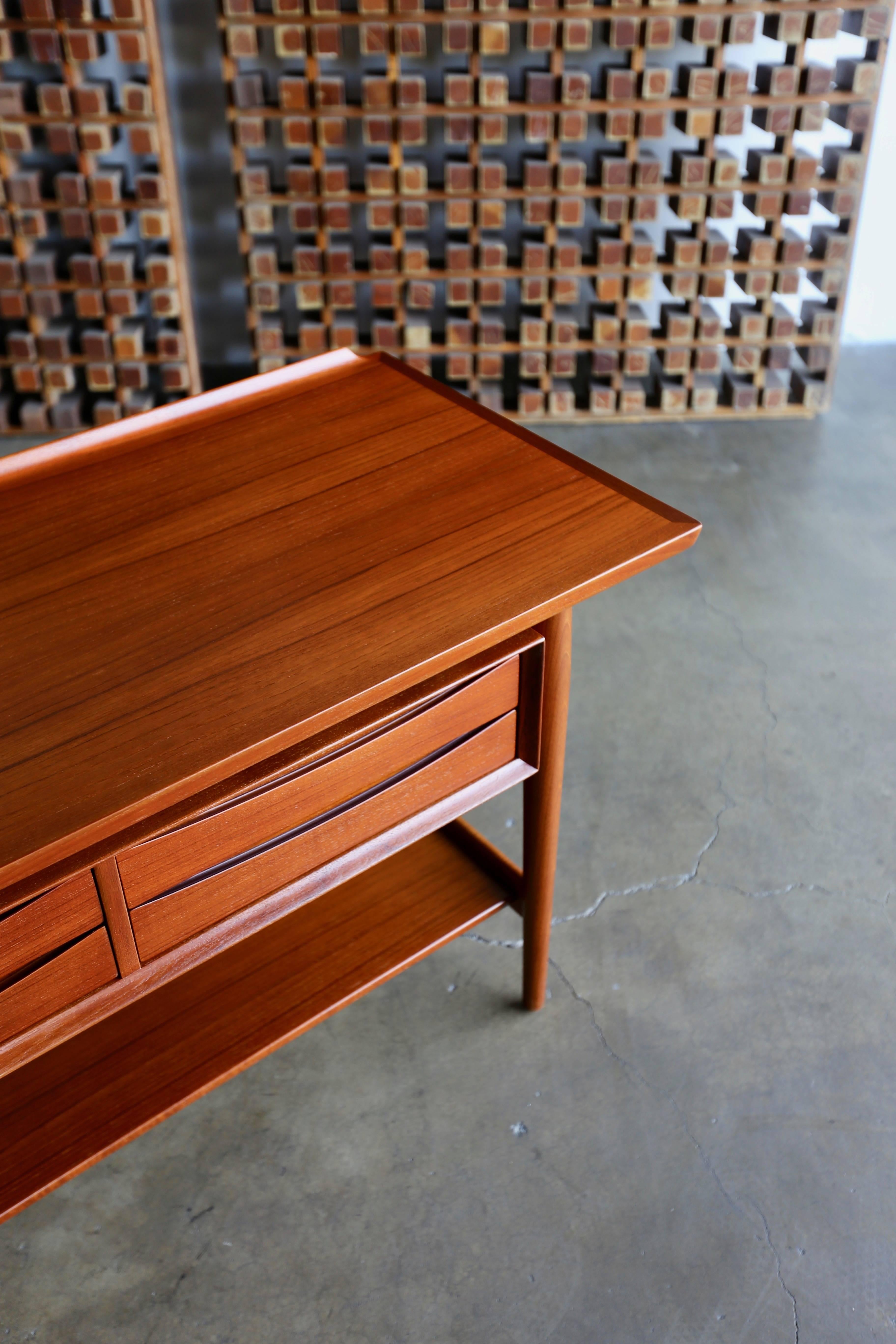 Console table by Arne Vodder for Sibast Mobler. This piece has been professionally restored. Four bow tie drawers with a finished back. This piece retains the original Sibast Mobler label.