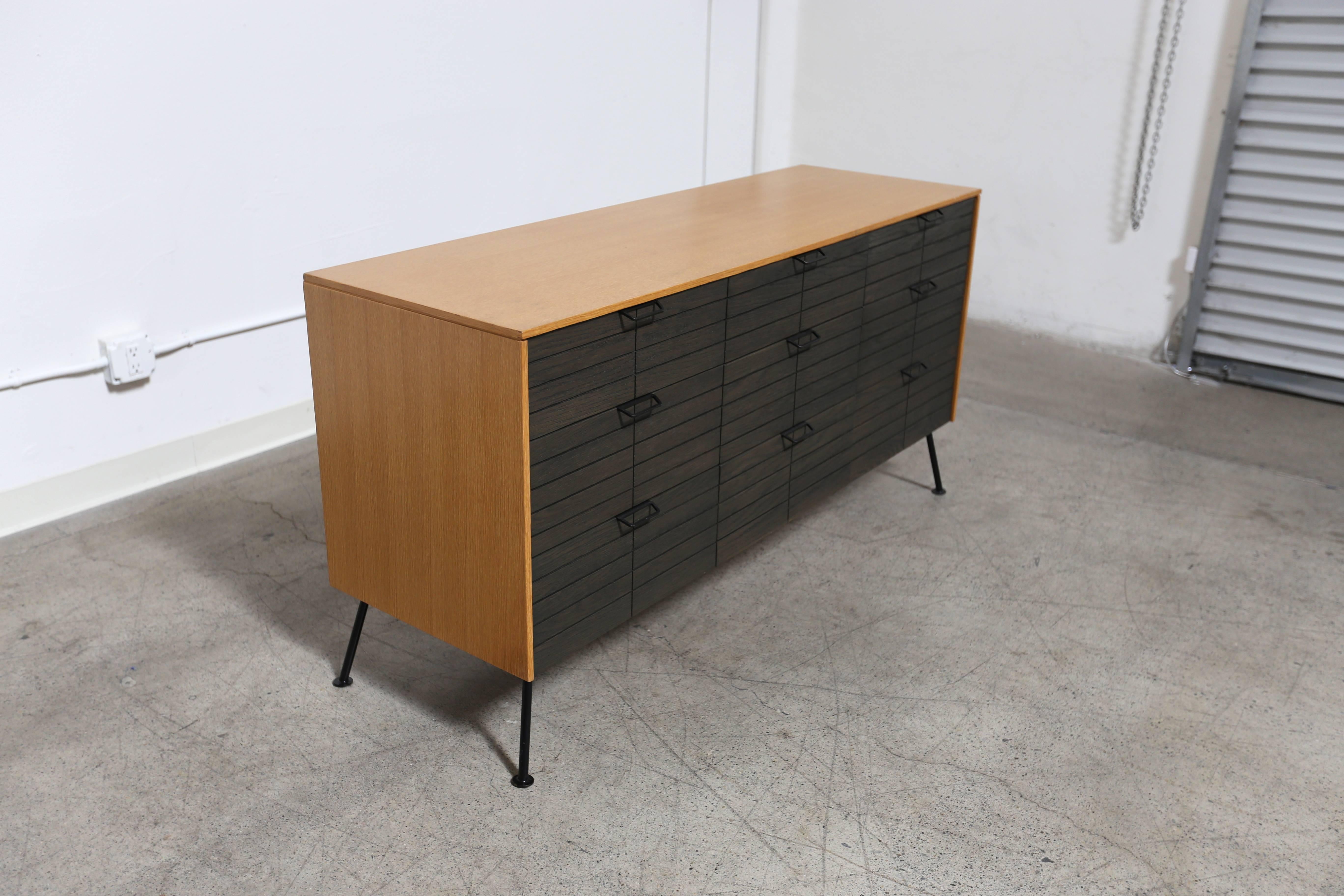 Dresser by Raymond Loewy for Mengel Furniture Company. The top center drawer has the original vanity mirror option. 

The cabinet measures 59.25 wide.
The overall width is 60.50 from foot to foot.