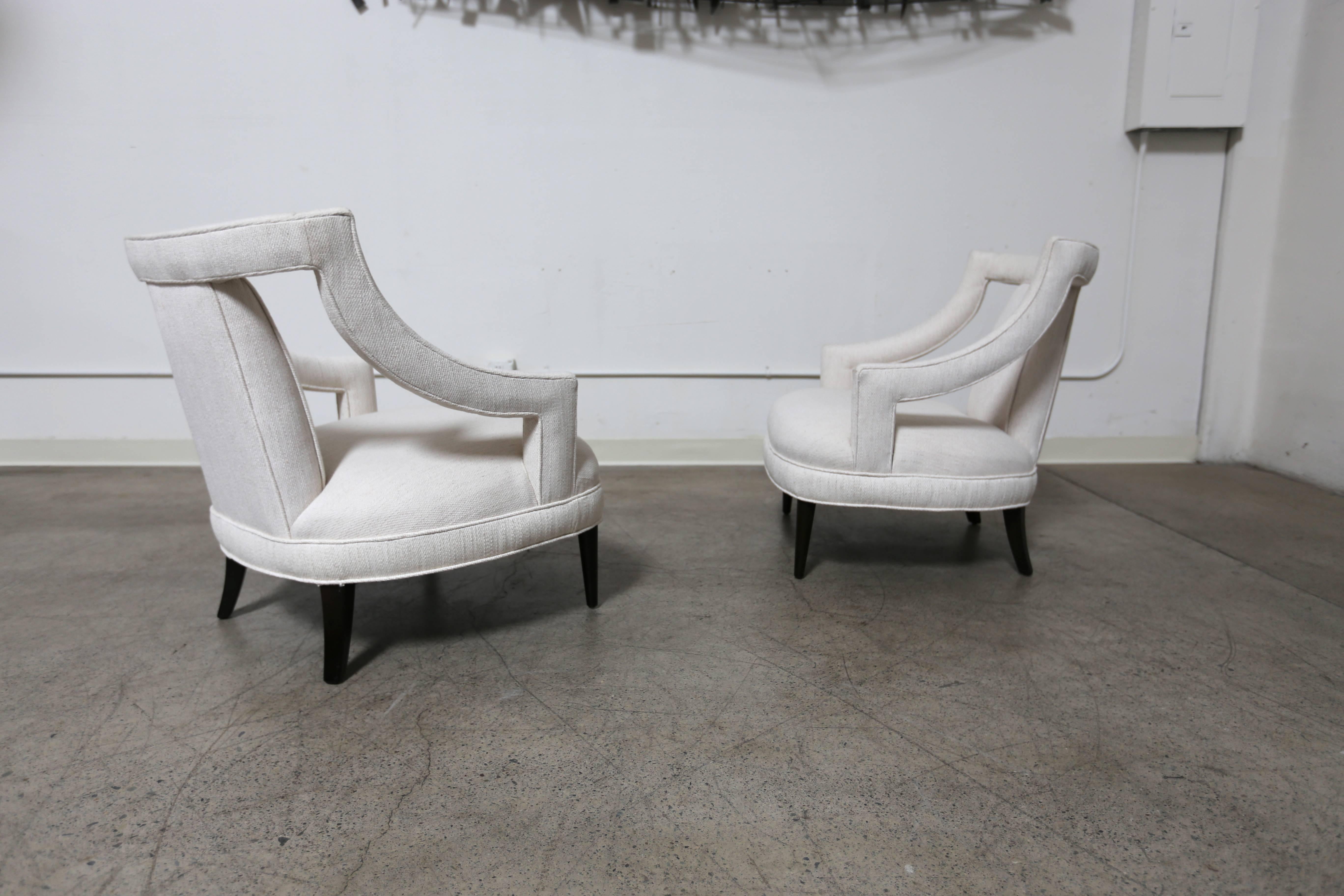 Classic pair of open arm lounge chairs.