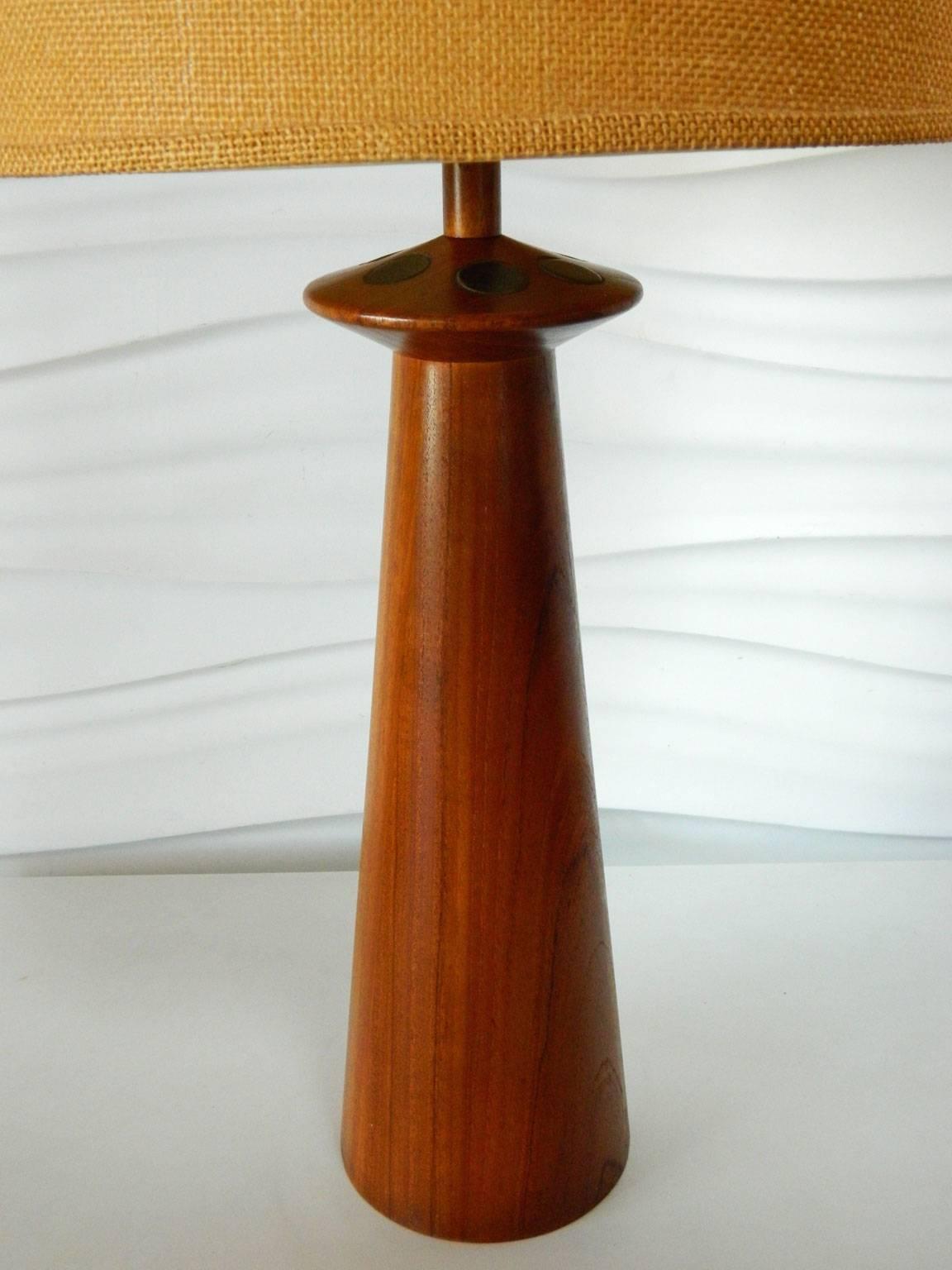 Designed by Gordon and Jane Martz, this walnut lamp features round, matte black ceramic tile inserts.
