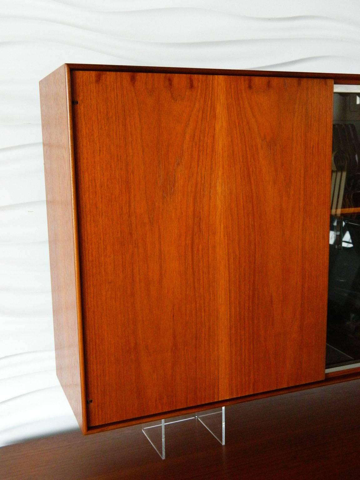 This George Nelson Thin Edge cabinet has one door and two sliding glass doors. It is designed to free-float on a wall. 

This is a wonderful companion piece to our George Nelson Thin Edge sideboard.

