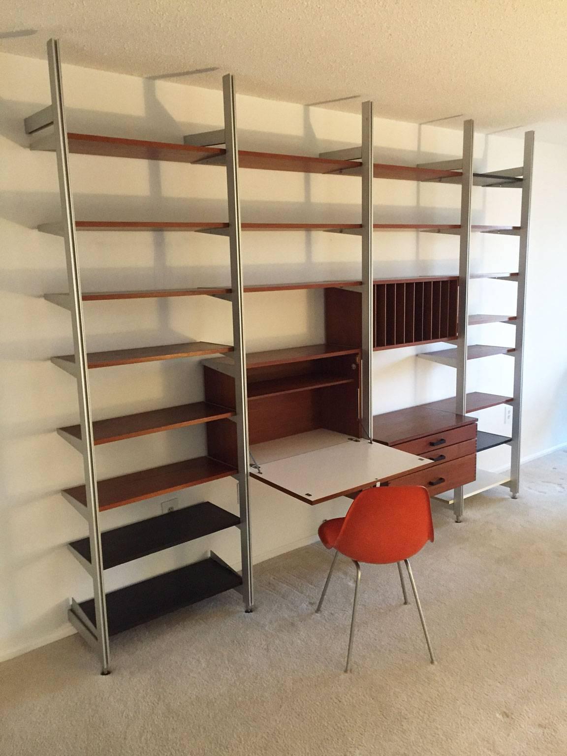 The comprehensive storage system, better known as the CSS, was originally designed by George Nelson in the 1950s. This four-bay system consists of a drop-front desk, three drawers, a slotted cabinet and 20 shelves.