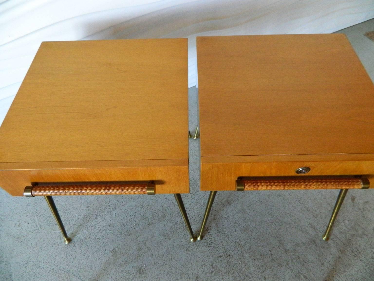 This handsome pair of T.H. Robsjohn-Gibbings nightstands for Widdicomb feature cane-wrapped pulls and brass legs. One nightstand has a manufacturer-installed lock with key.