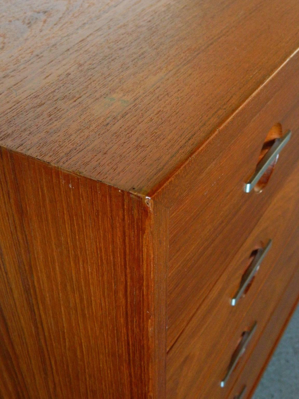 Handsome teak chest of drawers designed by Danish designer Hans Wegner for RY Mobler in the 1970s. Metal hardware, teak legs, and a finished back are some of the beautiful details of this piece. 