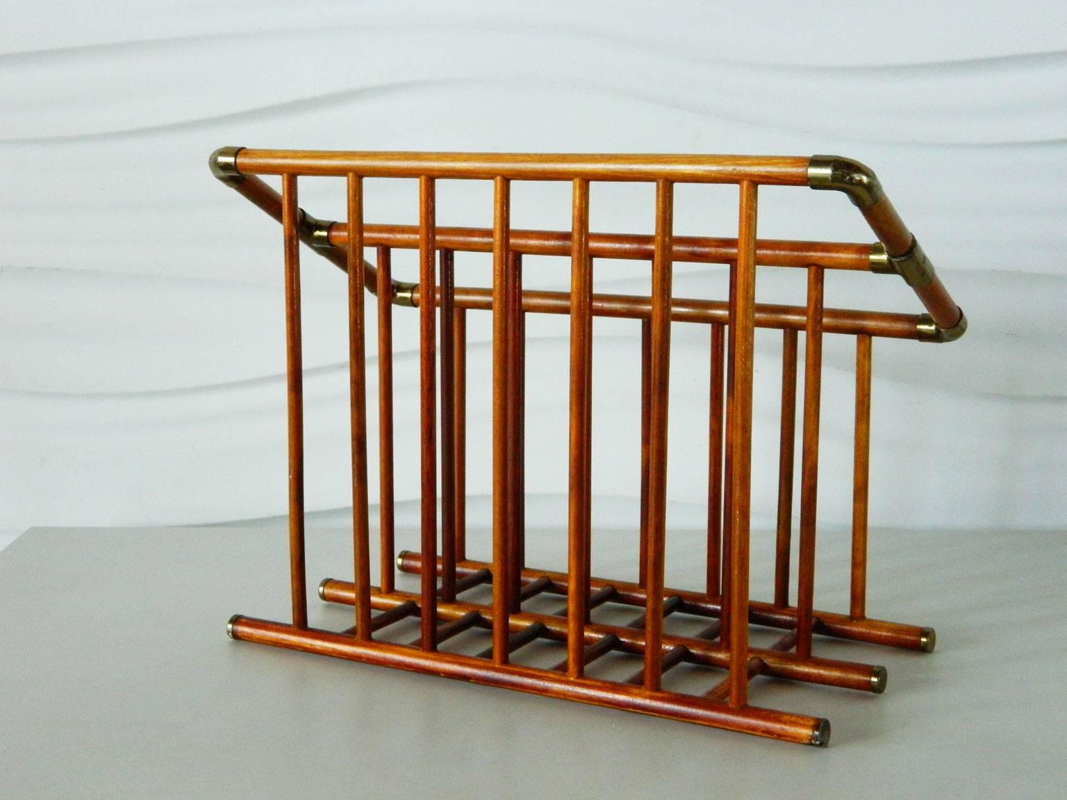 Simple, elegant rattan magazine holder features two sections to hold periodicals. Metal accents/joinery have been plated in brass.