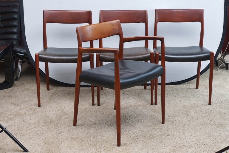 For J. L. Møller, these chairs have rosewood frames in a stunning form. They are well marked. The six side chairs show wear to the leather seats, while the two armchairs have been reupholstered. They are sturdy, structurally sound, and have clean,