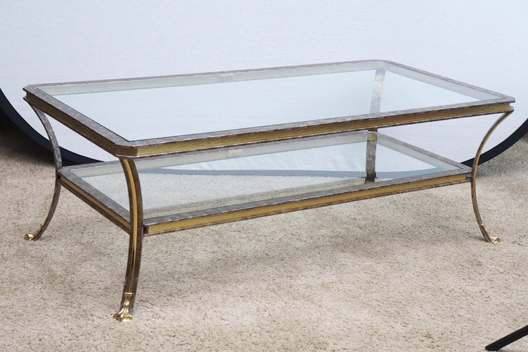 This elegant coffee table with mottled metal finish works well where either brass or steel pieces would be a plus. The 
