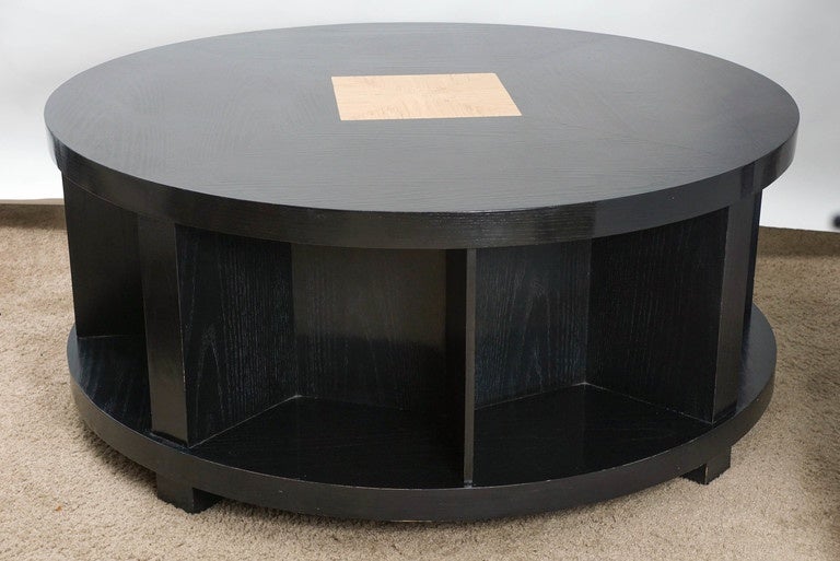 Large and lovely circular coffee table, with ebonized wood and lighter center area. A perfect place for that something special!!! Purchased in 1989, this ebonized piece boasts black lacquer with central and open sides, for magazines, books, etc.