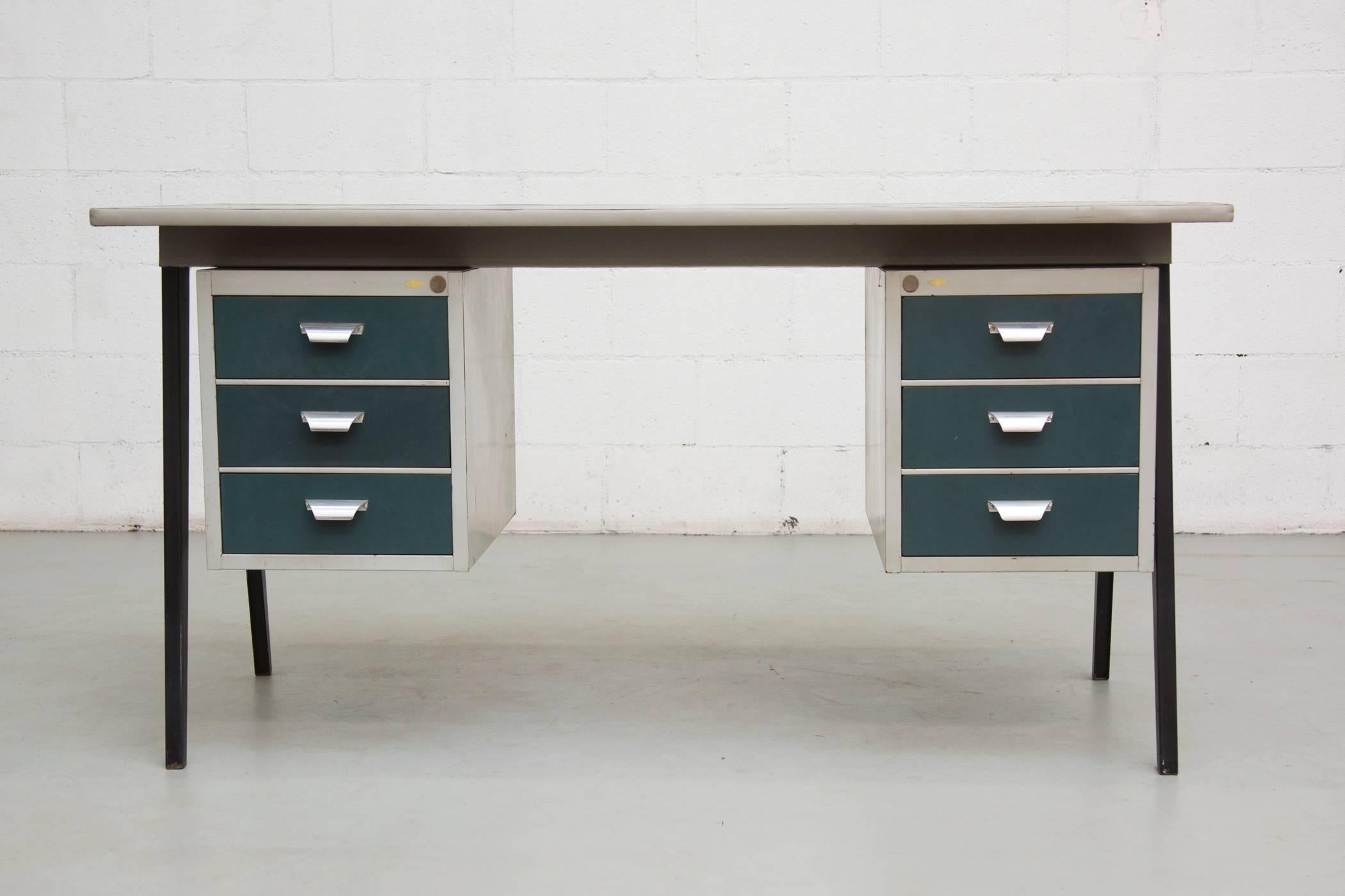 Perfect Prouve style legs hold the black linoleum top with two sets of stacking drawers all in enameled metal. Original condition with visible wear consistent with its age and usage.