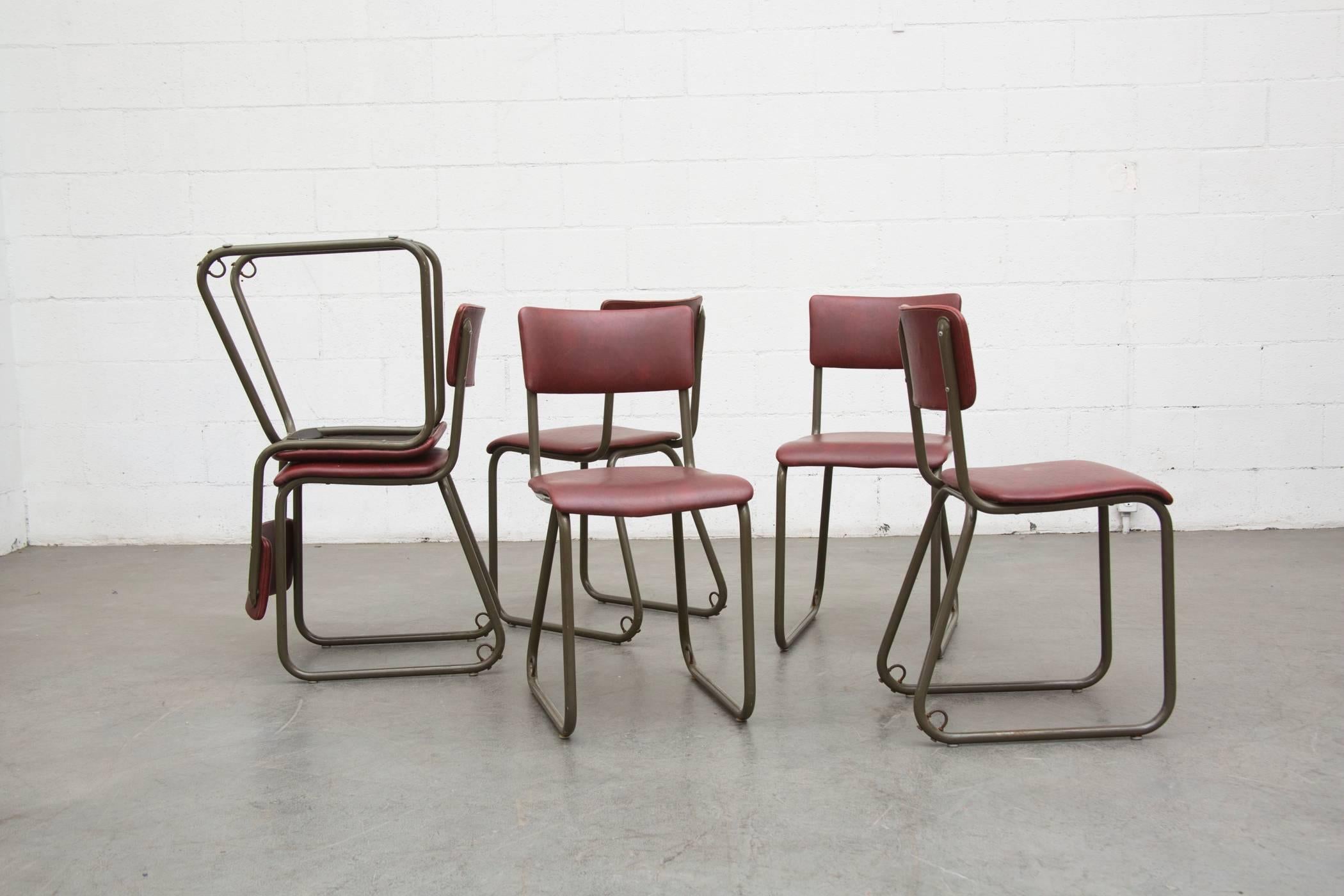 Industrial tubular metal chairs with burgundy vinyl upholstered seat and back. Original condition. Priced as a set.