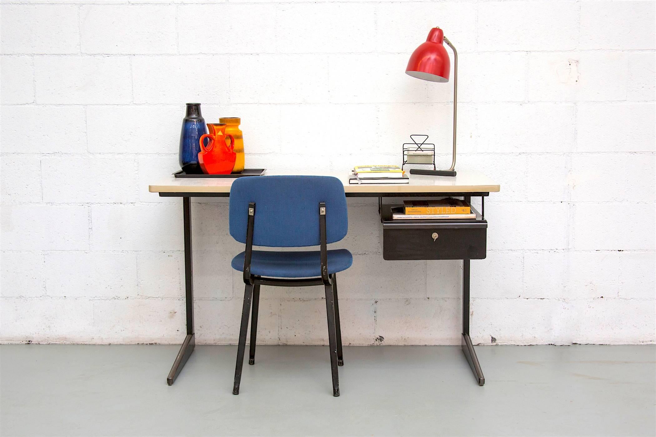 Black Friso Kramer desk with faux grass paper Formica top. Enameled black frame and floating drawer with key! Original condition, visible wear, some signs of surface rust.