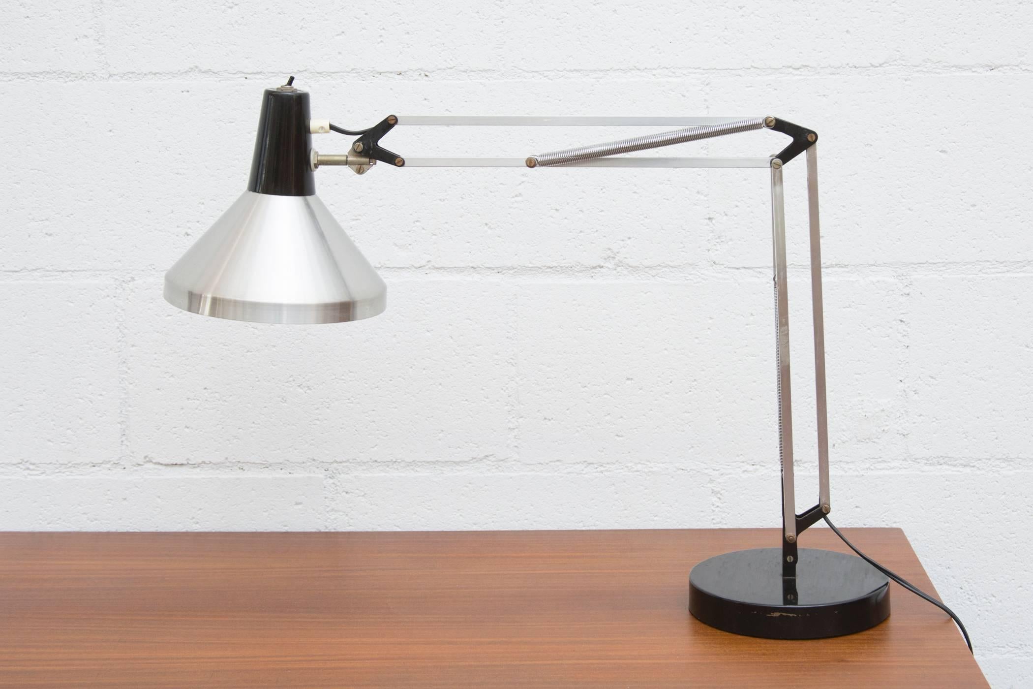 Black and chrome Hala Zeist drafting task lamp with lack enameled base and articulating arm. In original condition with some wear to black enamel.