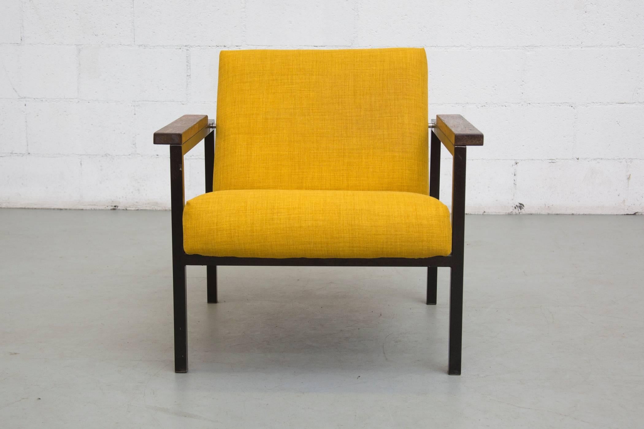 Swanky newly upholstered mustard yellow lounge chair with black enameled metal frame and wenge armrests. Frame and armrests in original condition