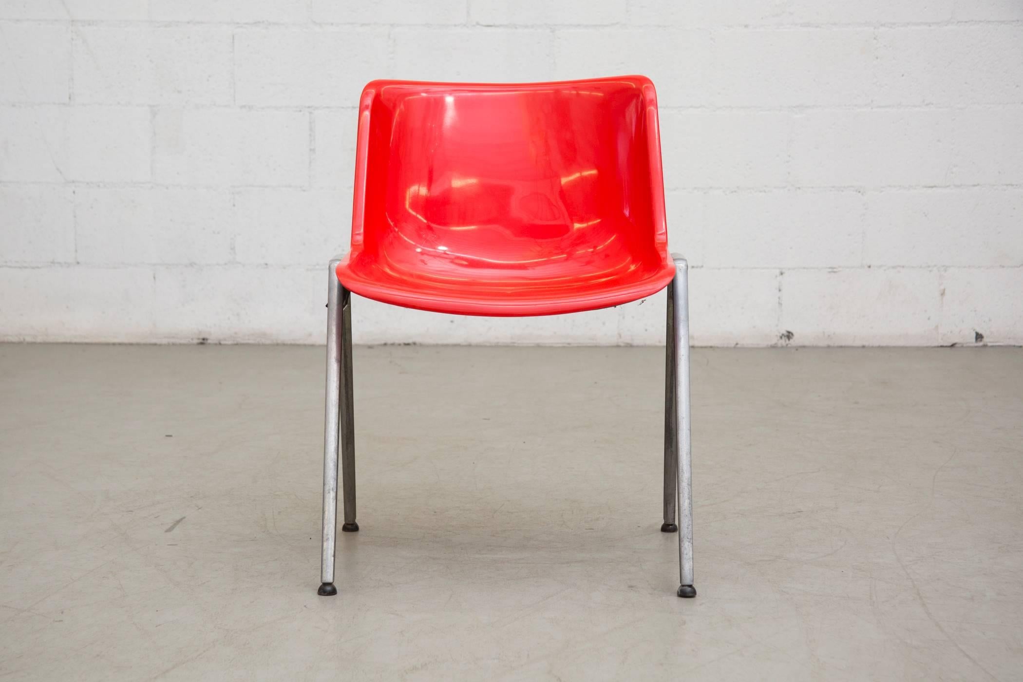 Red stacking chairs by Osvaldo Borsani for Tecno, Italy. Metal frame with ABS shell. Some plastic sides are missing, visible scratching of acrylic shell, otherwise good original condition for their age and usage.