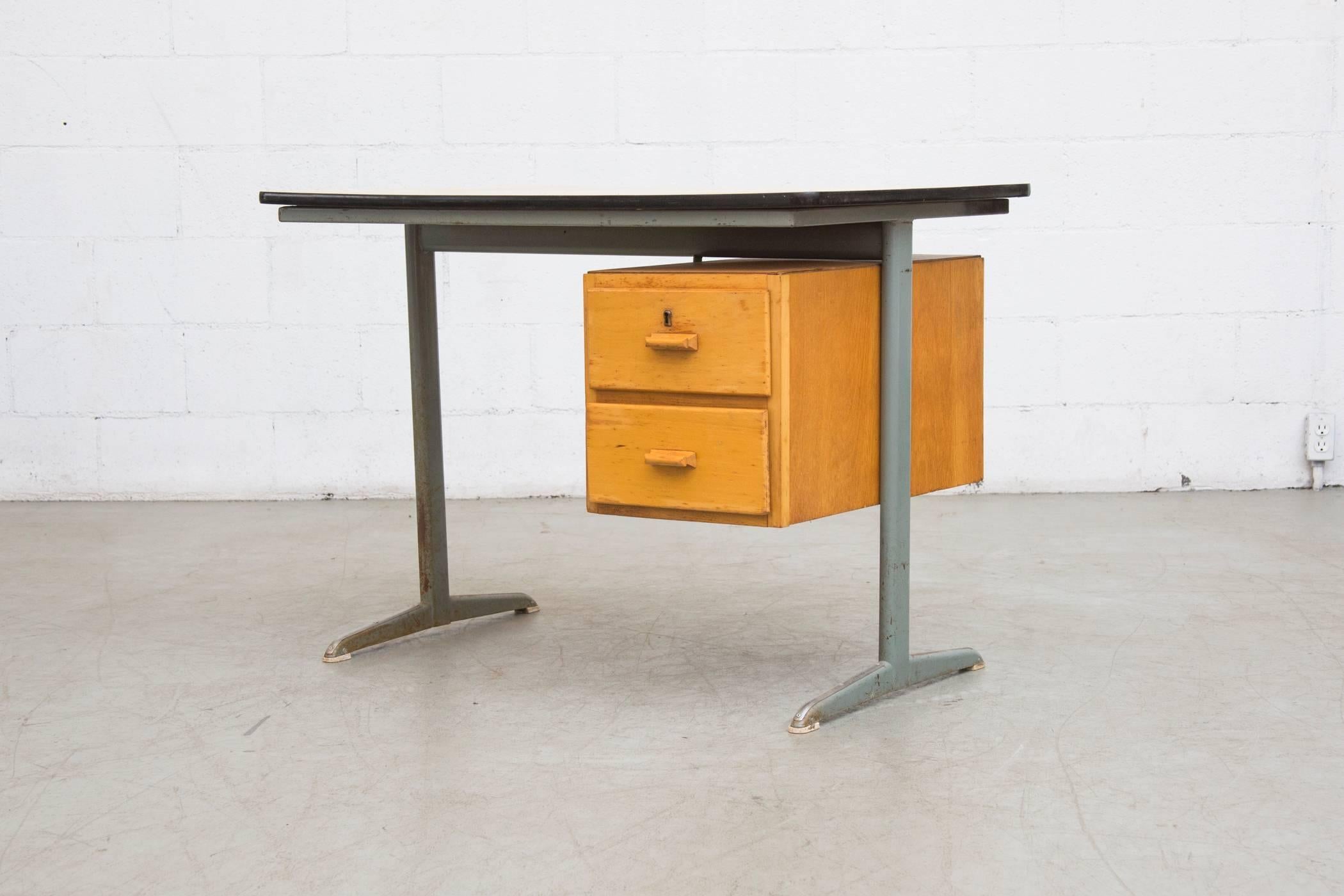 Cute little Industrial Dutch school desk with original metal frame and birch side stacking drawers and formica top. The desk is in original condition with visible signs of wear. A second one is available, please request pictures for its condition.