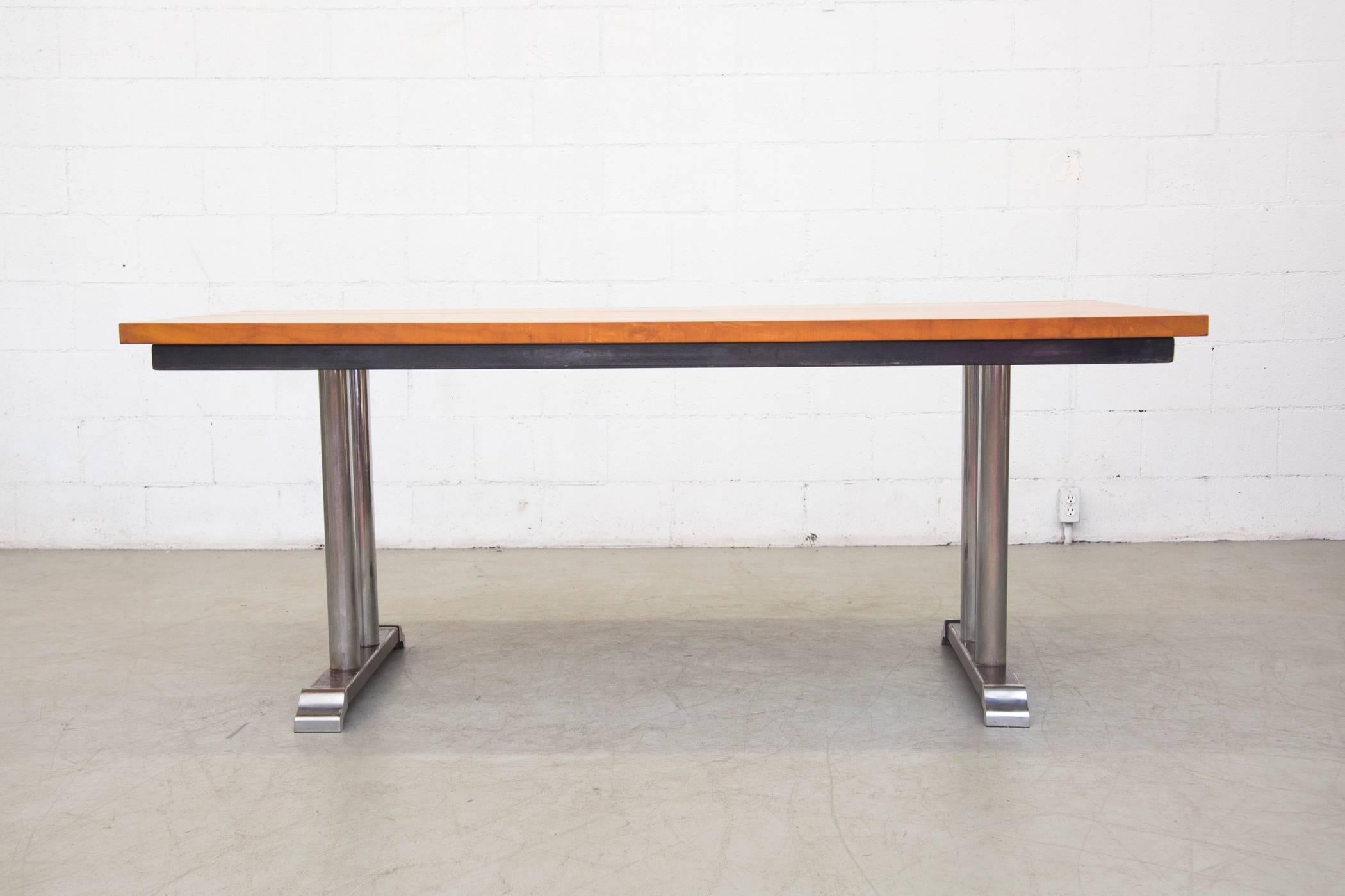 Incredibly rare solid wood topped Industrial conference table with enameled steel frame and chromed base. Visible enamel loss on the base and visible scratching to chrome. Otherwise, good original condition. Heavy beast!

.