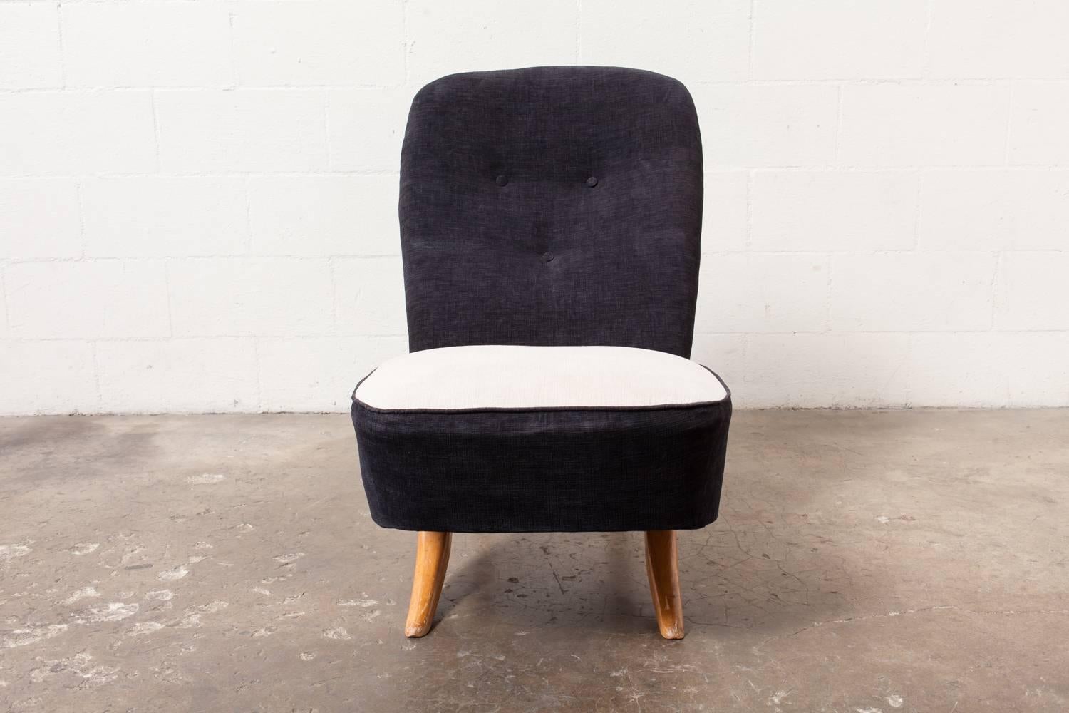 Unique tension set construction. The back and seat are two separate pieces that fit together like two pieces of a puzzle. Upholstery in black with white seat top. Original finished beechwood frame.