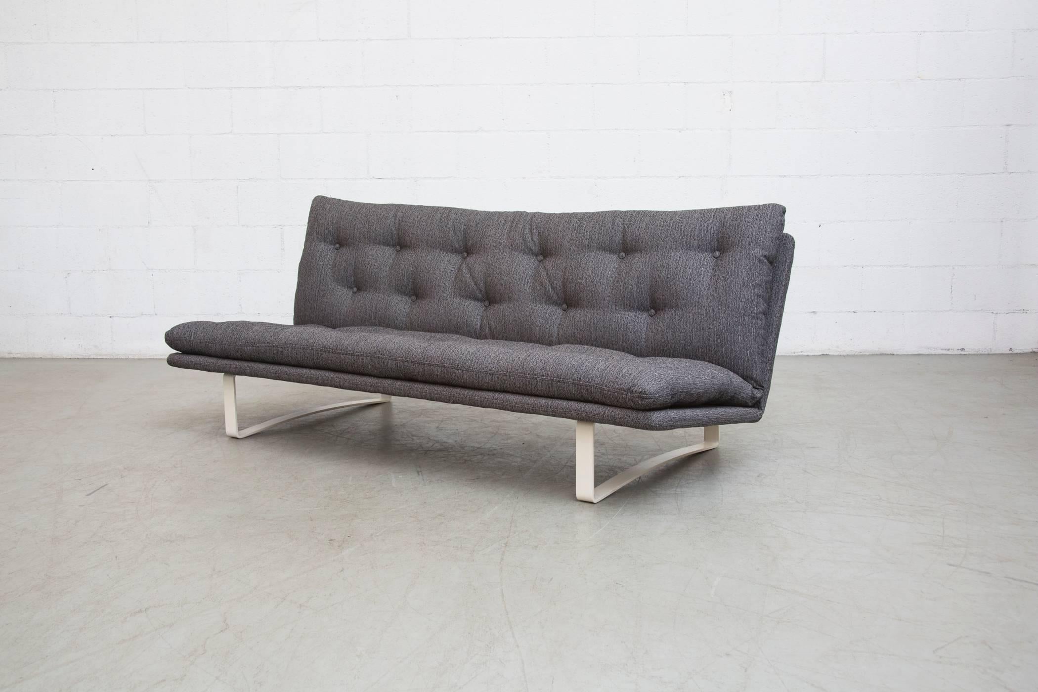 Amazing low, stealth and tufted three-seat sofa in new charcoal upholstery with bone enameled metal frame. Design by Kho Liang Ie in 1968 for Artifort, Holland. Frame in Good Condition with Some signs of wear.