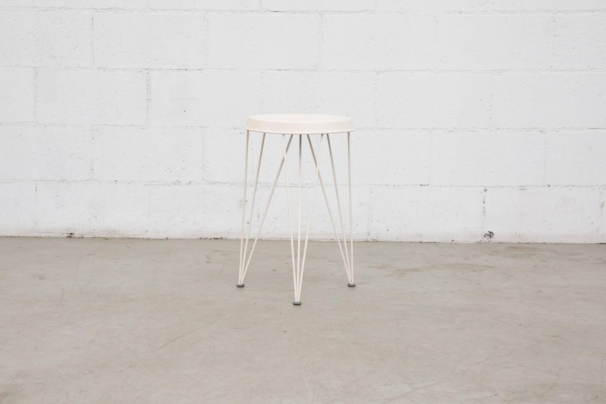 White on white Pilastro metal stool with enameled wire legs. 1950s production from The Netherlands. Previous repair done under seat. In original condition.